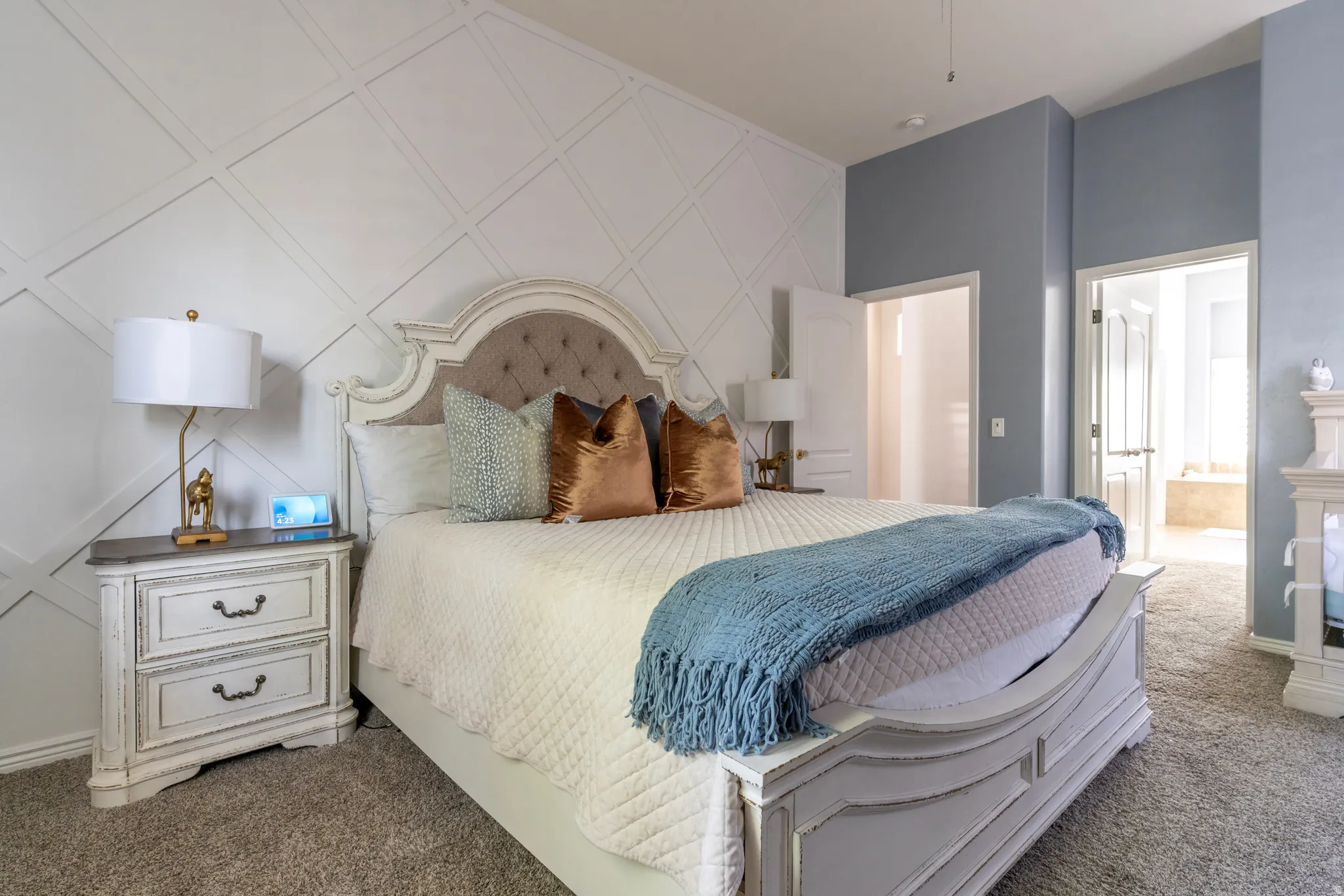 Bedroom with carpet, an accent wall, and ensuite bathroom