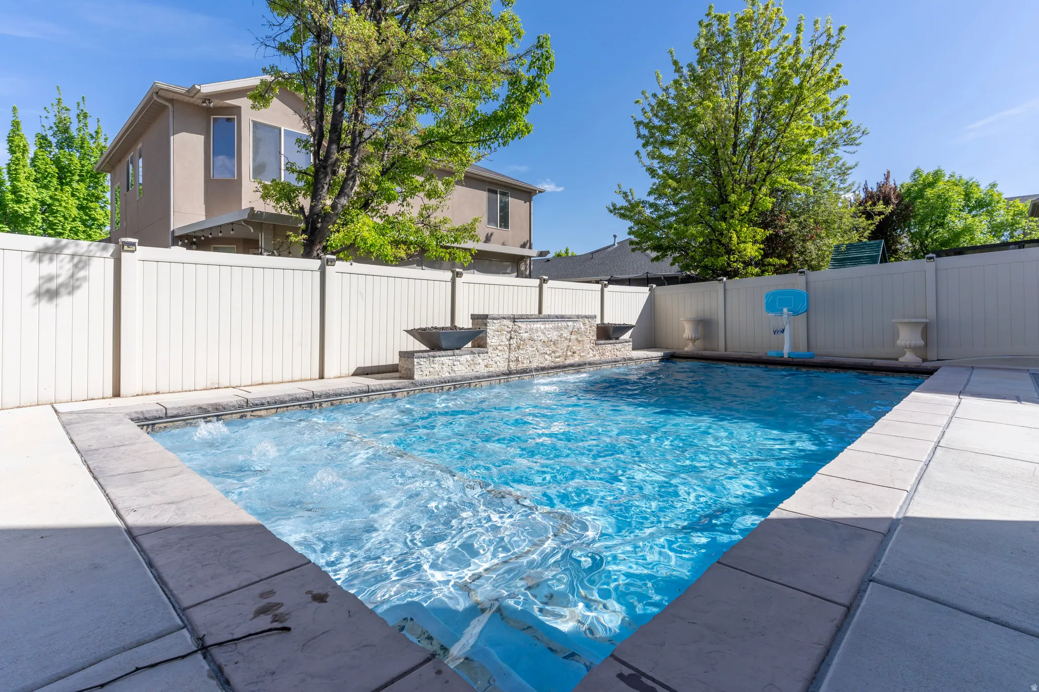 View of pool with a fenced backyard and patio surround