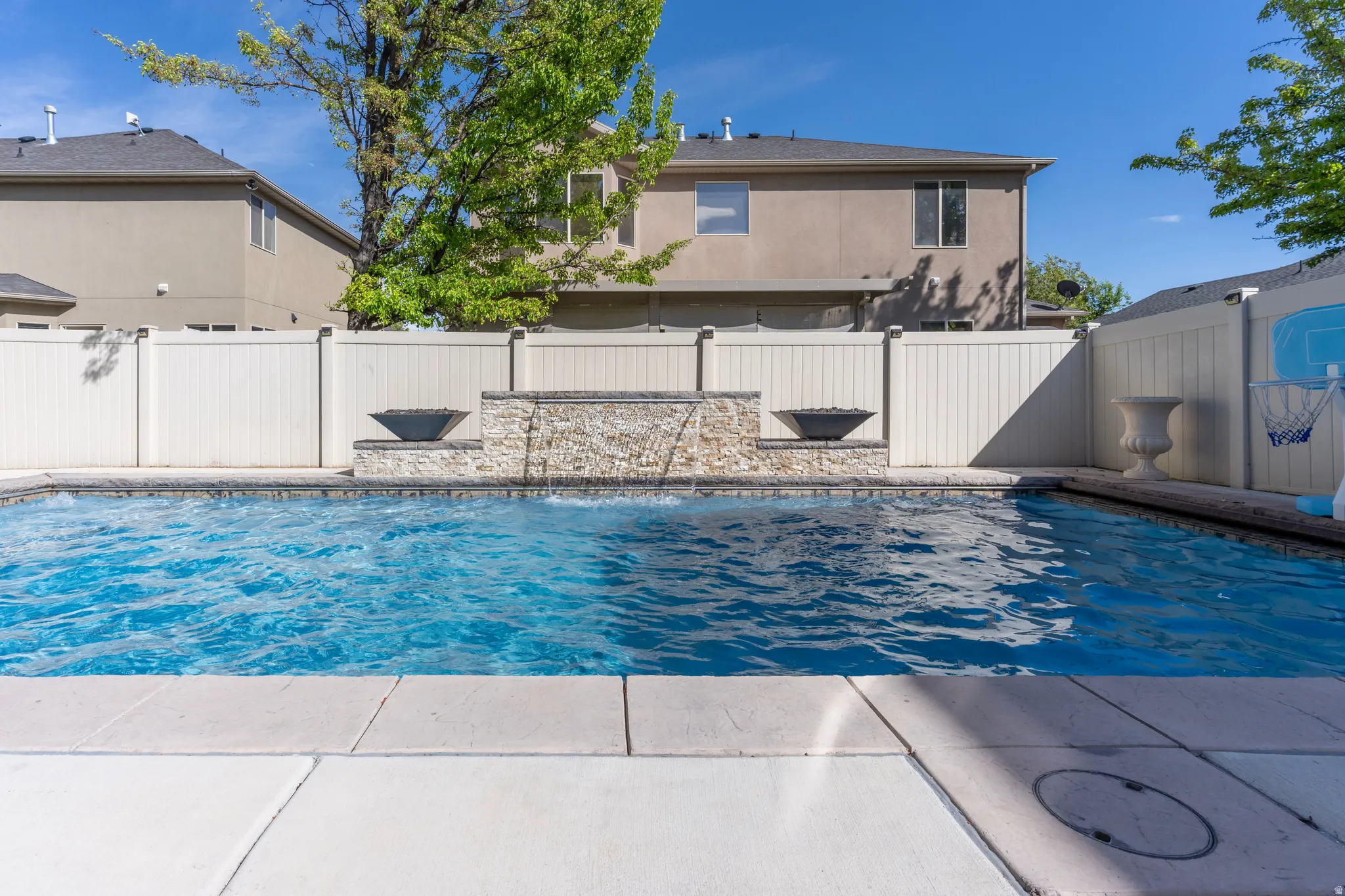 View of pool featuring a fenced backyard and patio surround