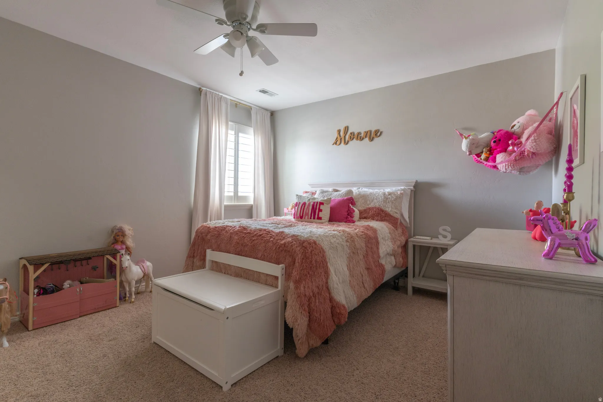 Bedroom with light colored carpet and ceiling fan