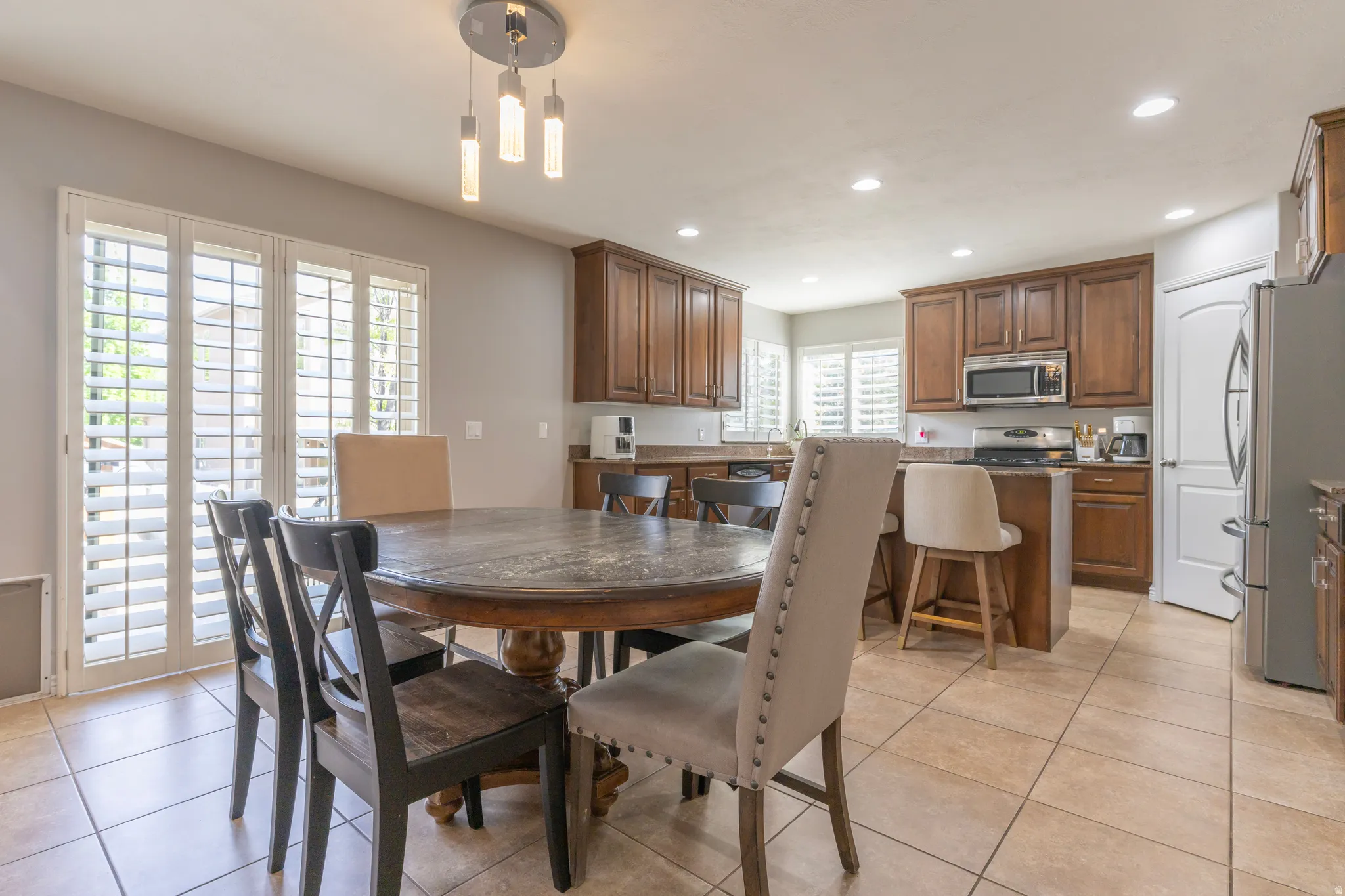 Dining area with recessed lighting and light tile patterned flooring