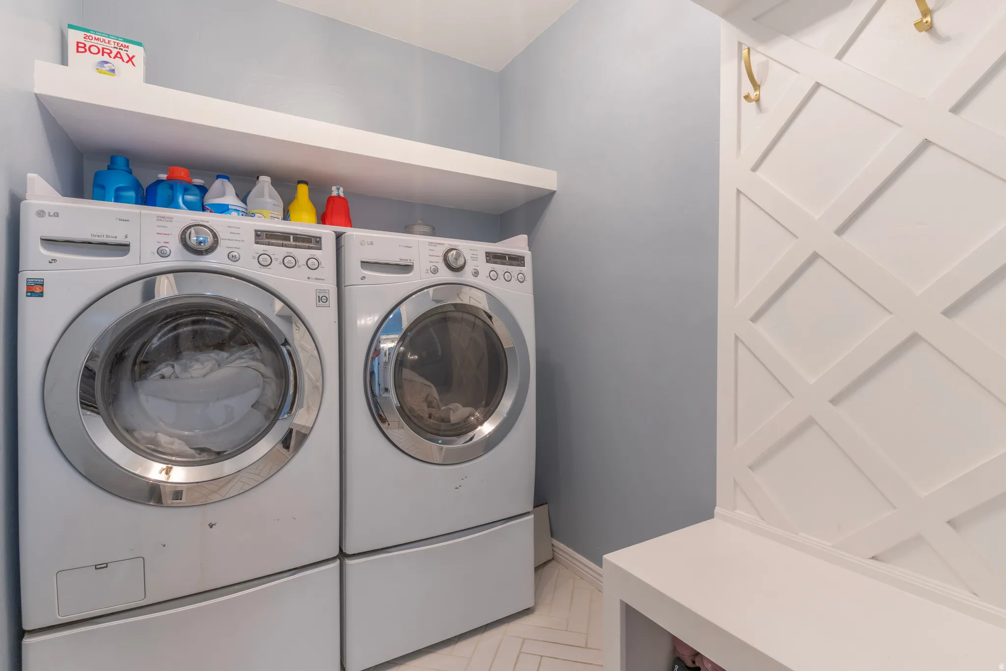 Laundry area featuring separate washer and dryer and baseboards