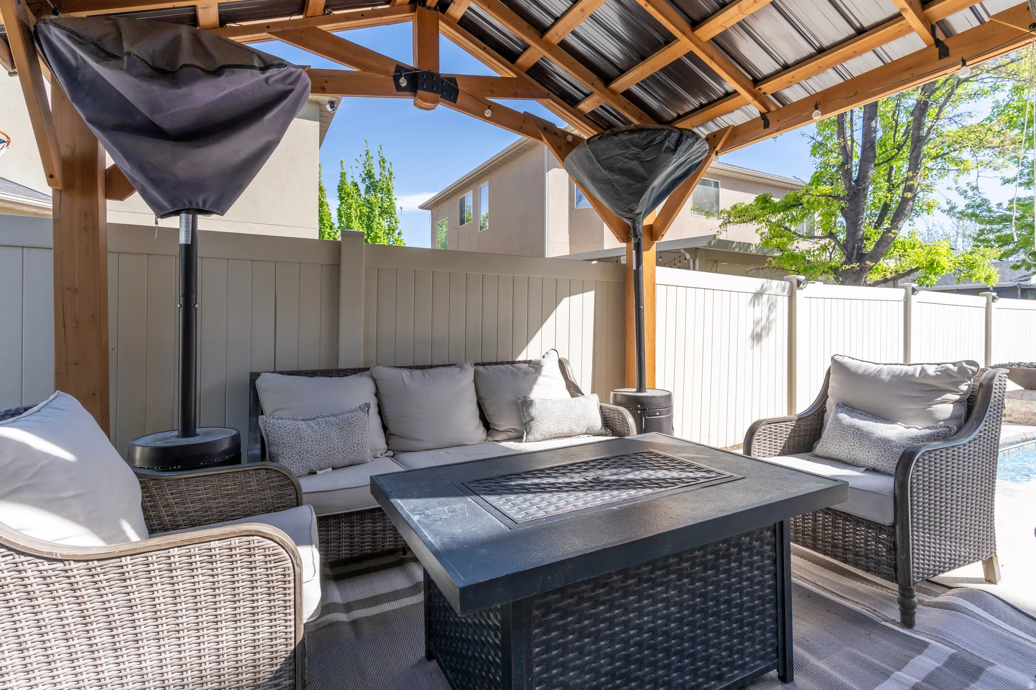 Fenced backyard with outdoor furniture and a patio