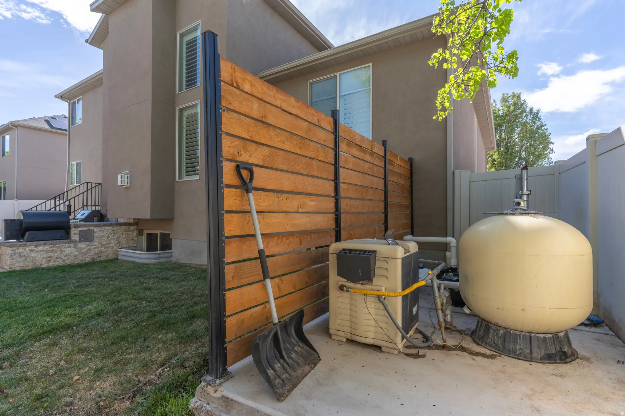 View of property exterior with stucco siding and a gate