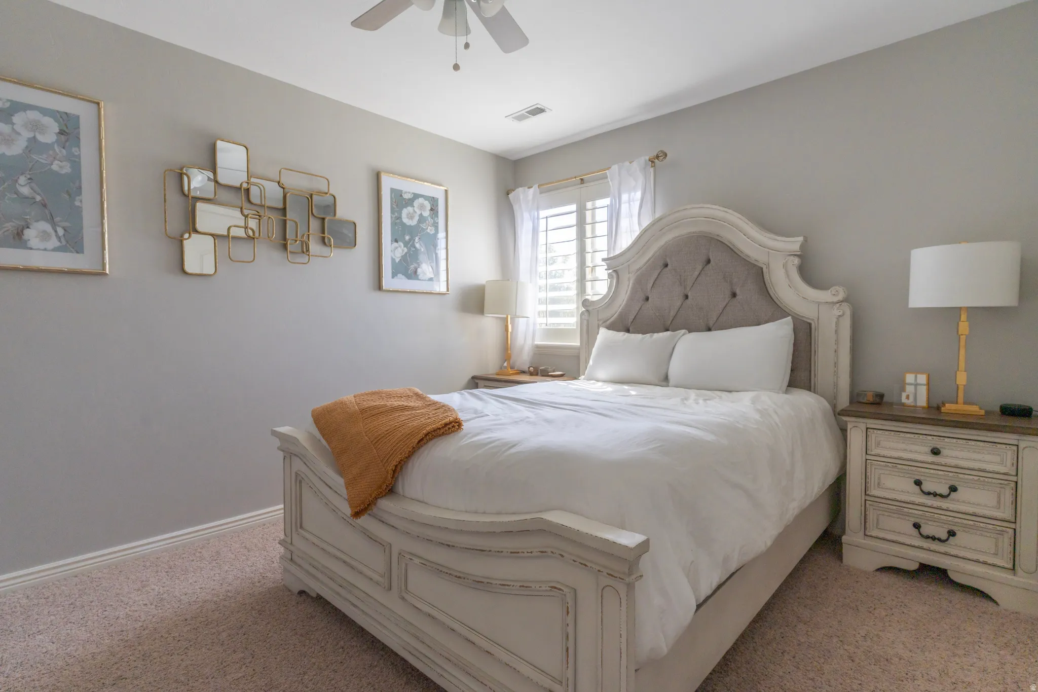 Bedroom with light colored carpet and ceiling fan