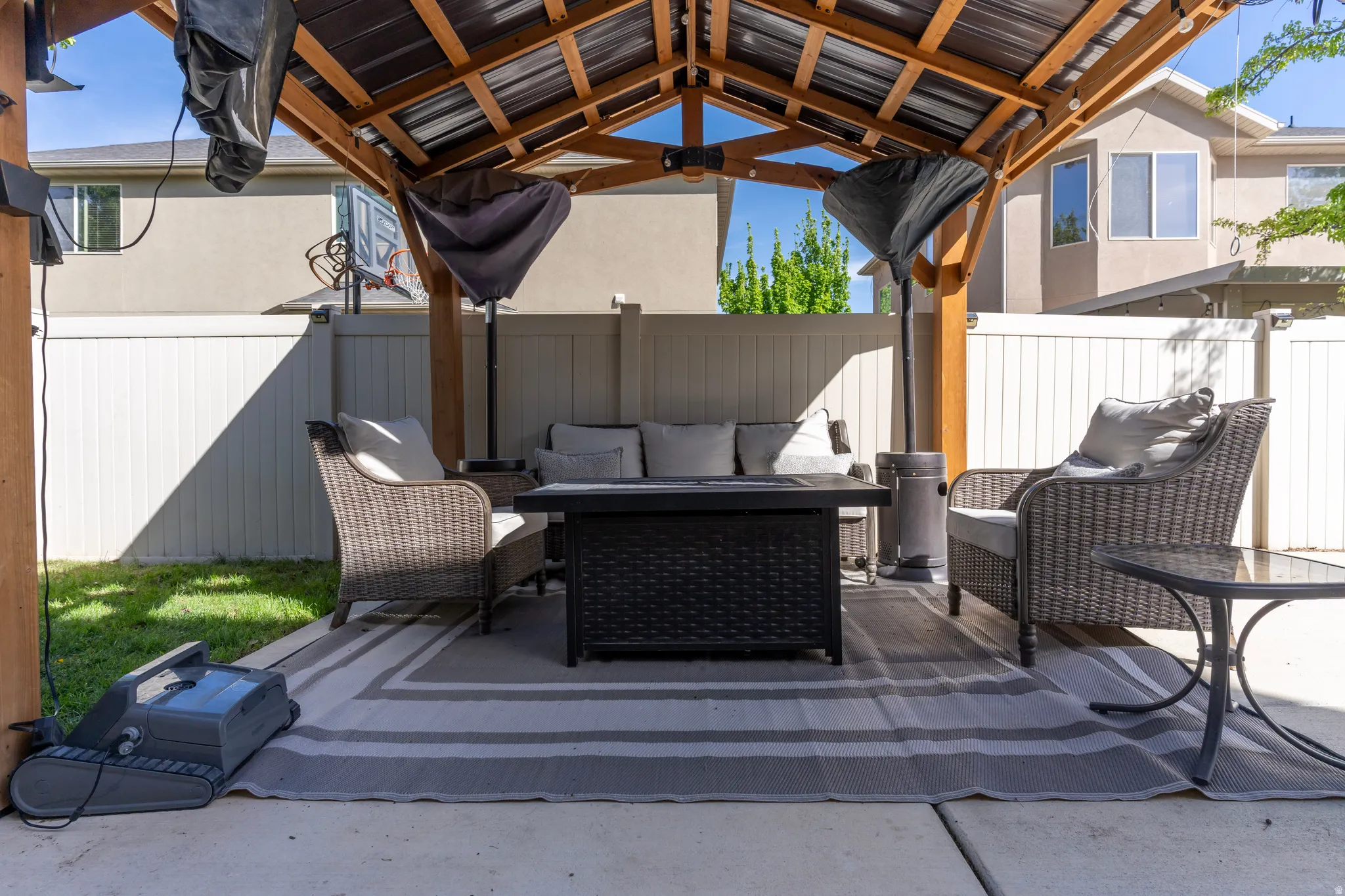 Fenced backyard with an outdoor lounge area and a patio area