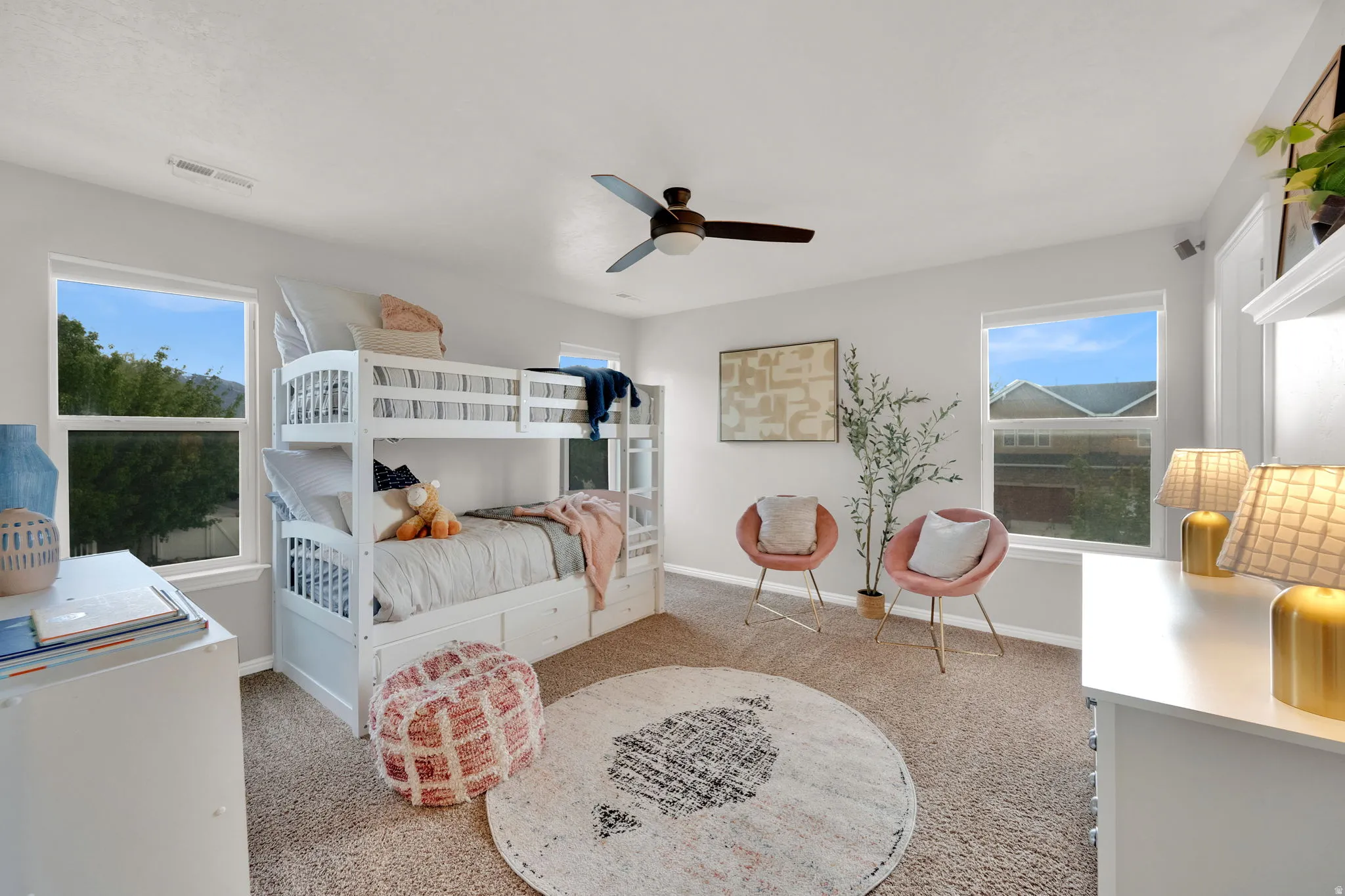 Large Bedroom with light carpet and ceiling fan