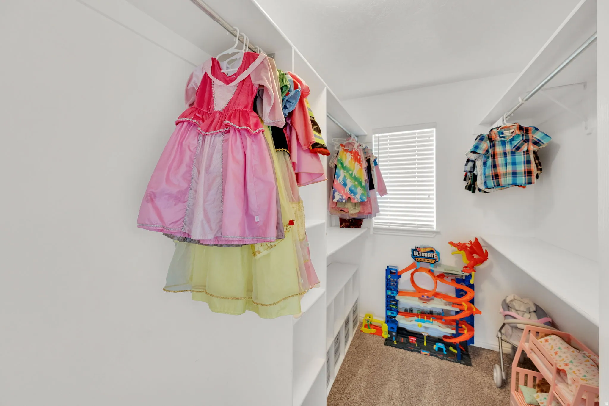 Walk in closet featuring light colored carpet