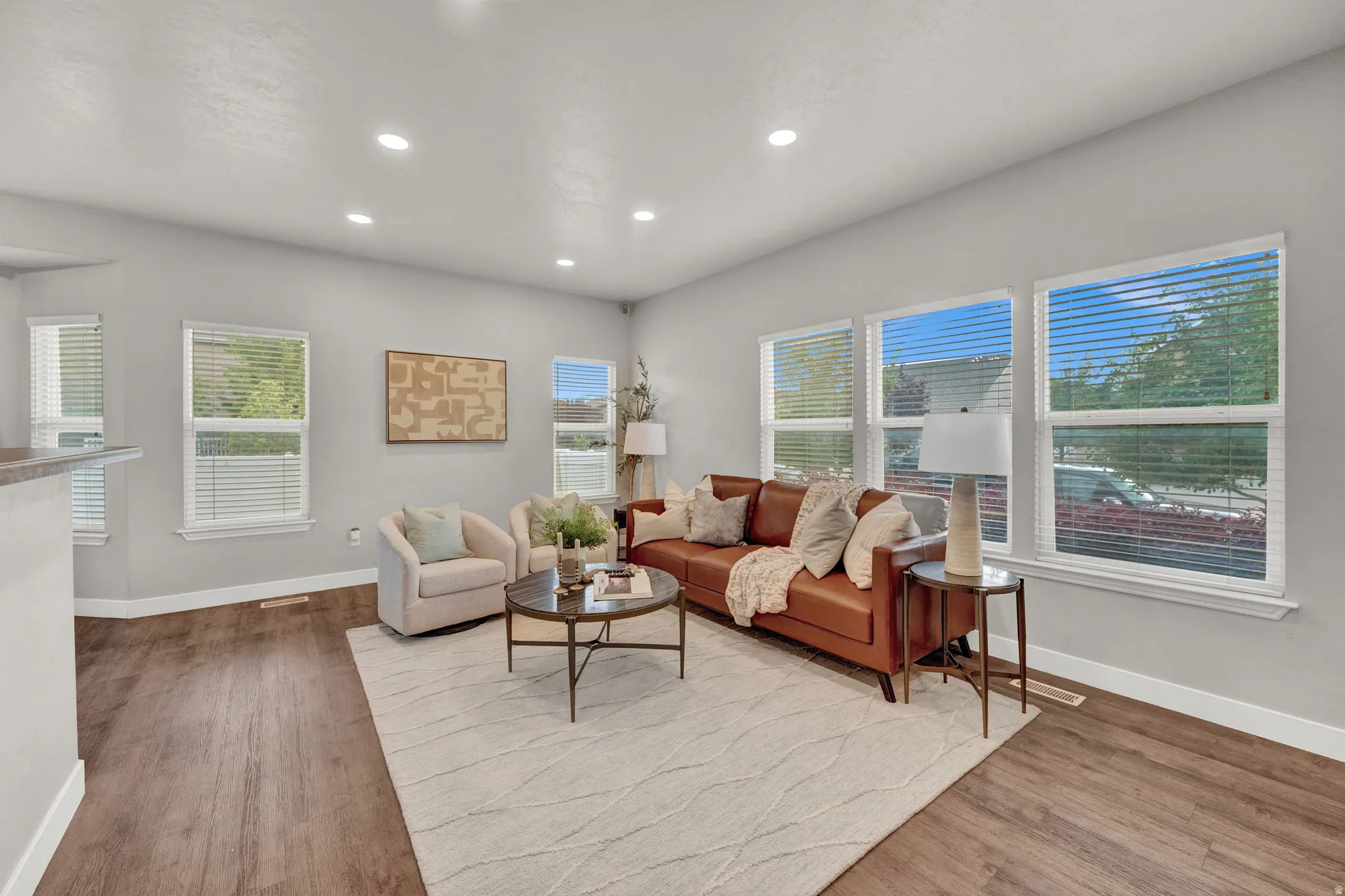 Living room with light wood finished floors and recessed lighting