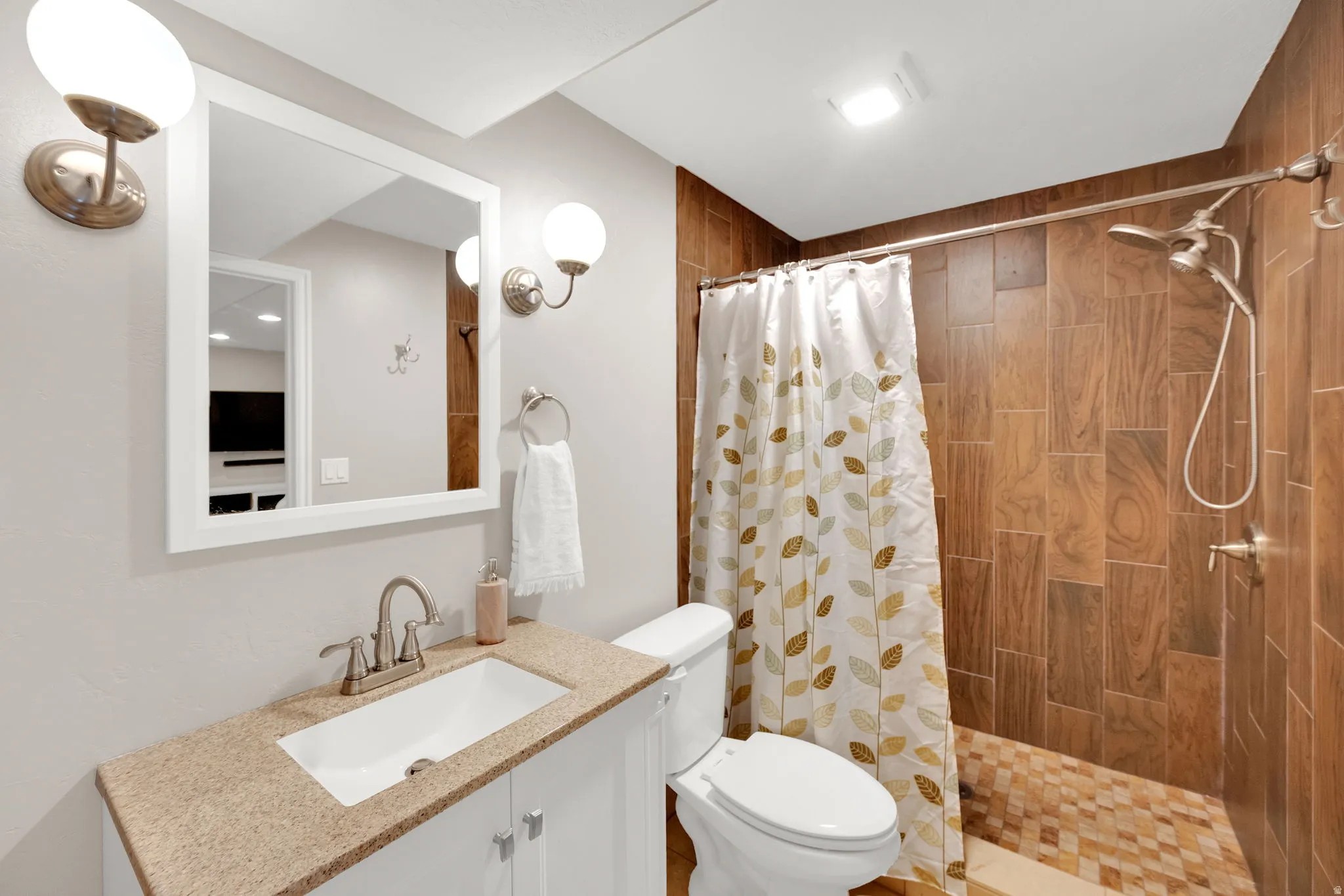 Full bathroom featuring vanity and a shower stall