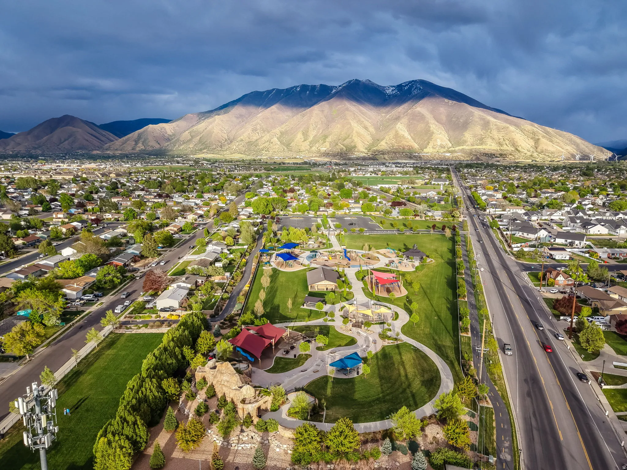 Aerial view of residential area with a mountain backdrop and All Abilities Park a few blocks away