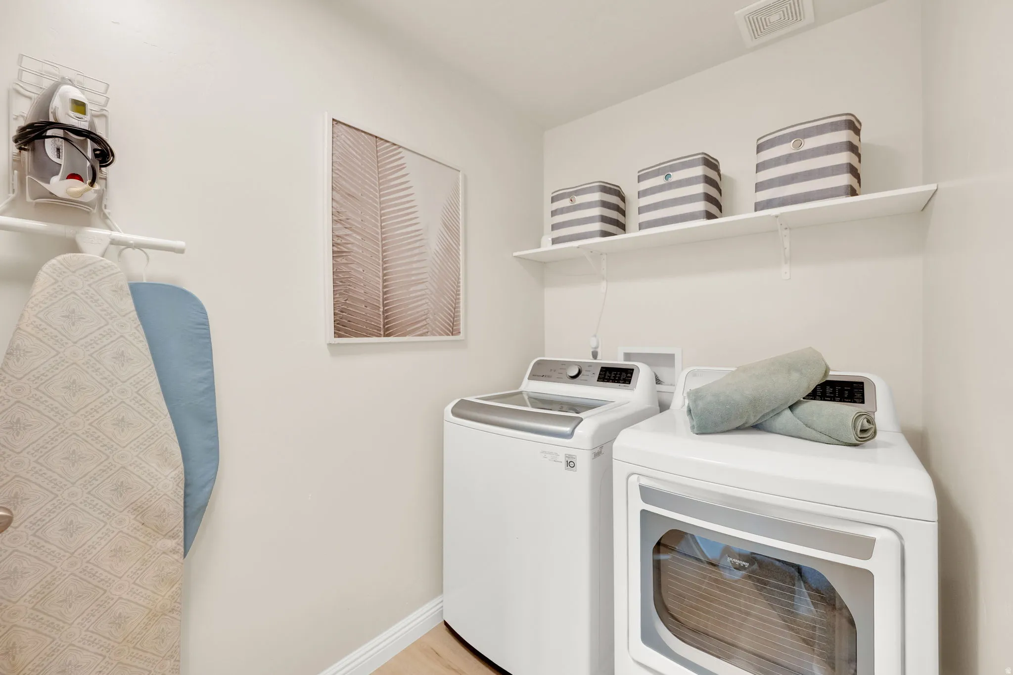 Laundry area with baseboards and washer and dryer