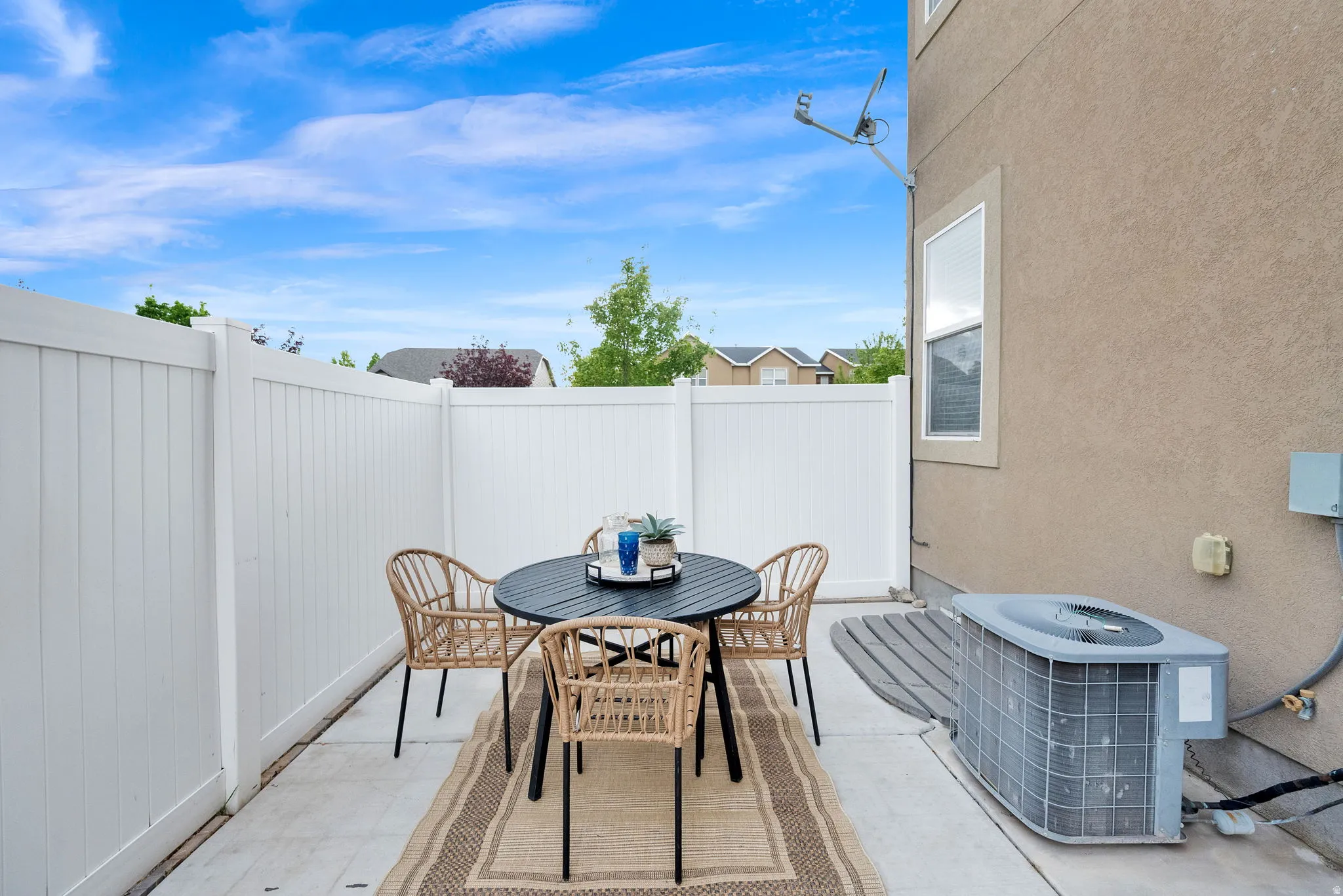 Fenced backyard featuring outdoor dining space and a patio