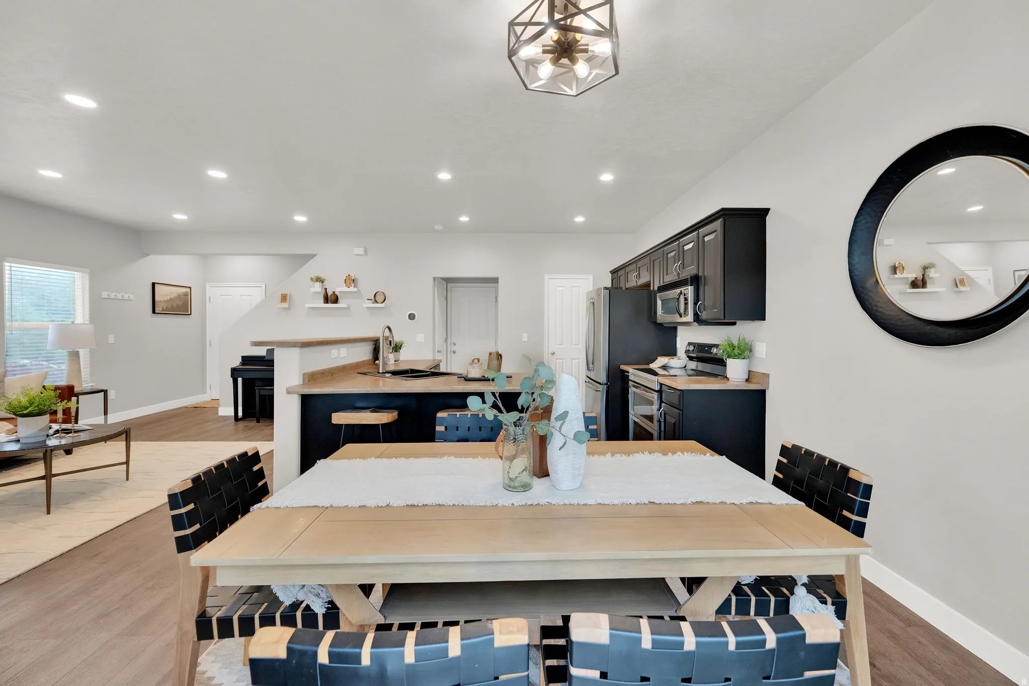 Dining space featuring light wood-type flooring and recessed lighting