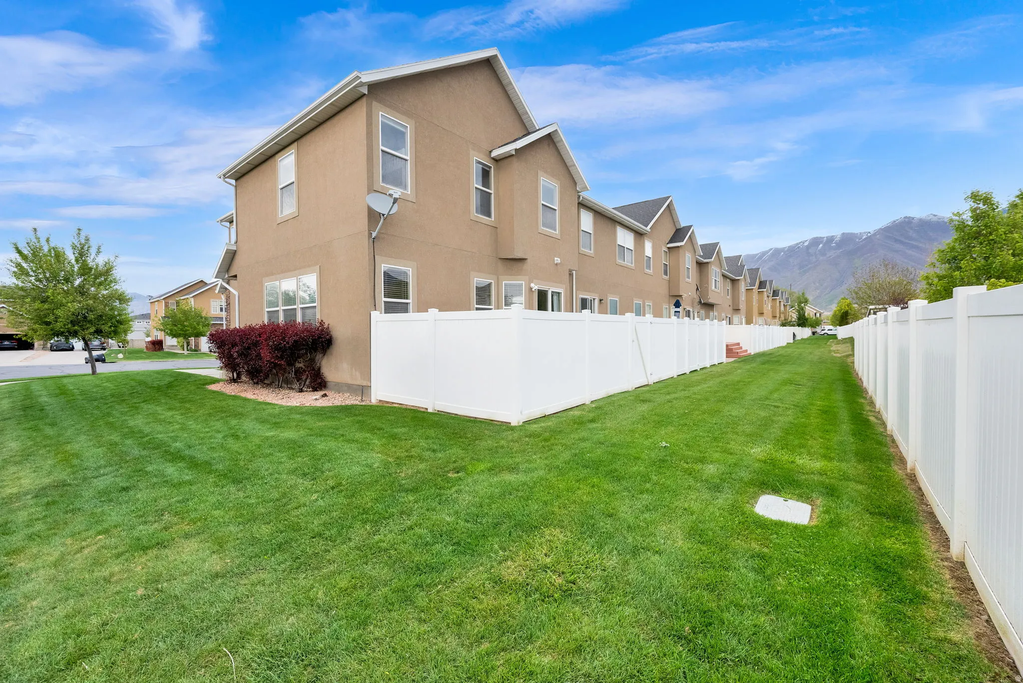 Rear view of property featuring stucco siding, a mountain view, and a residential view