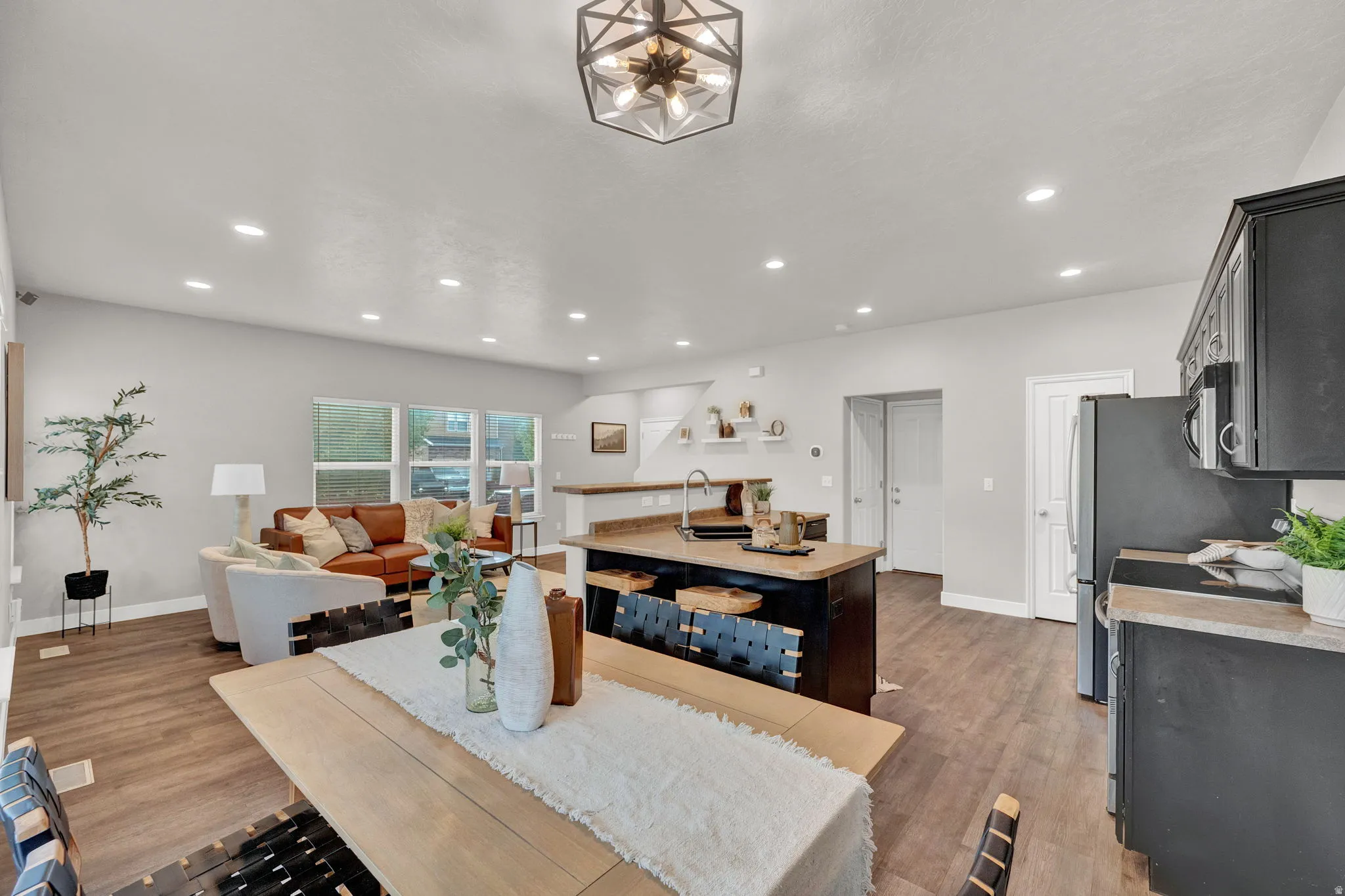 Dining room featuring dark wood-style floors and recessed lighting