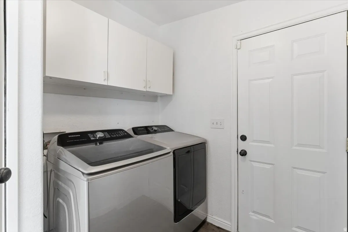 Laundry room with cabinet space and washing machine and clothes dryer