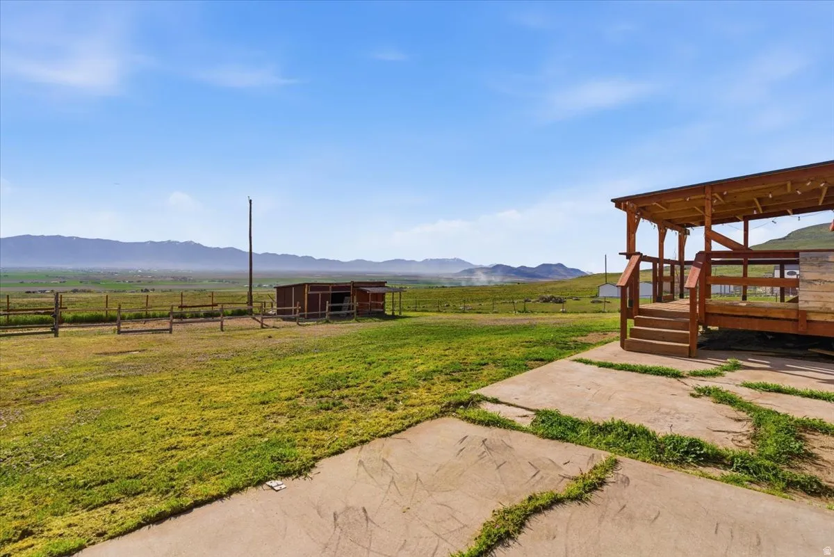 View of yard featuring a mountain view, a view of rural / pastoral area, and an outdoor structure