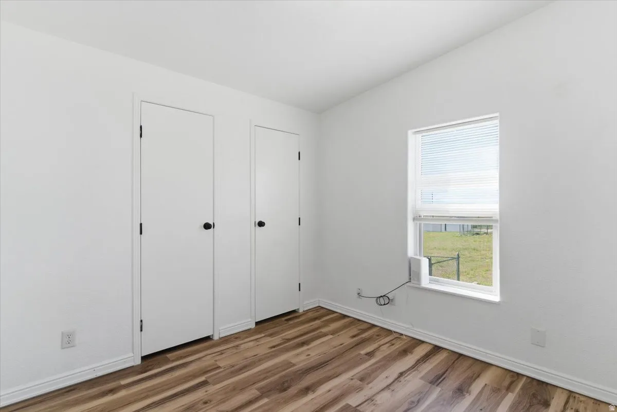 Unfurnished bedroom featuring baseboards and light wood-style floors