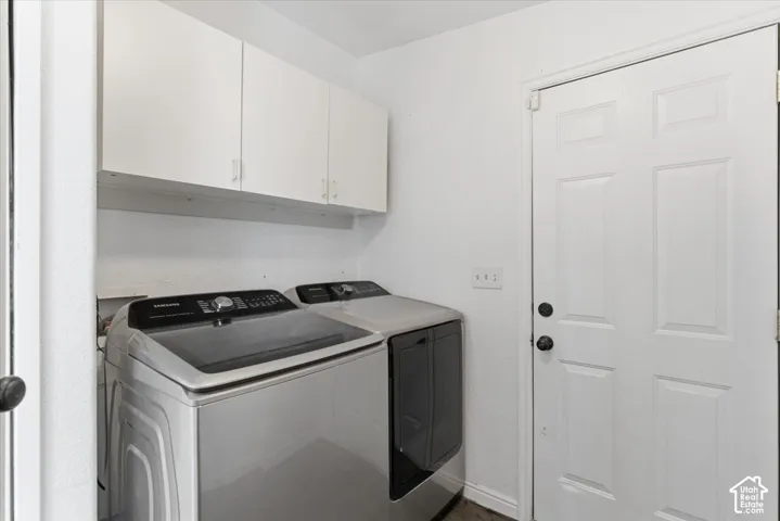 Laundry room with cabinet space and washing machine and clothes dryer