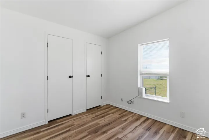 Unfurnished bedroom featuring baseboards and light wood-style floors