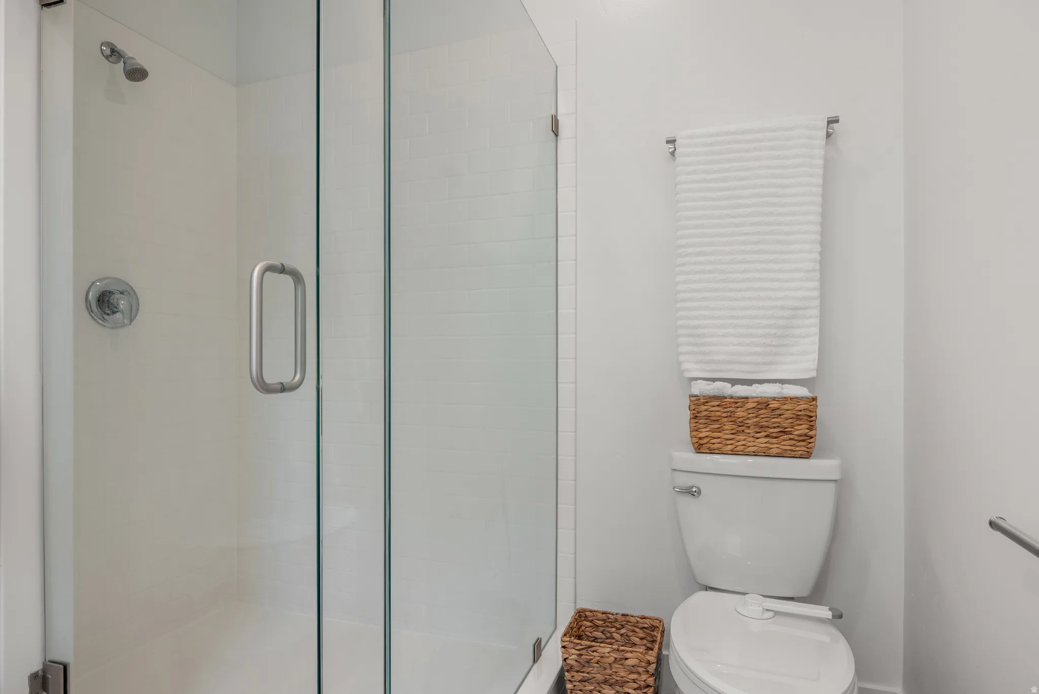 Bathroom featuring toilet and a shower stall
