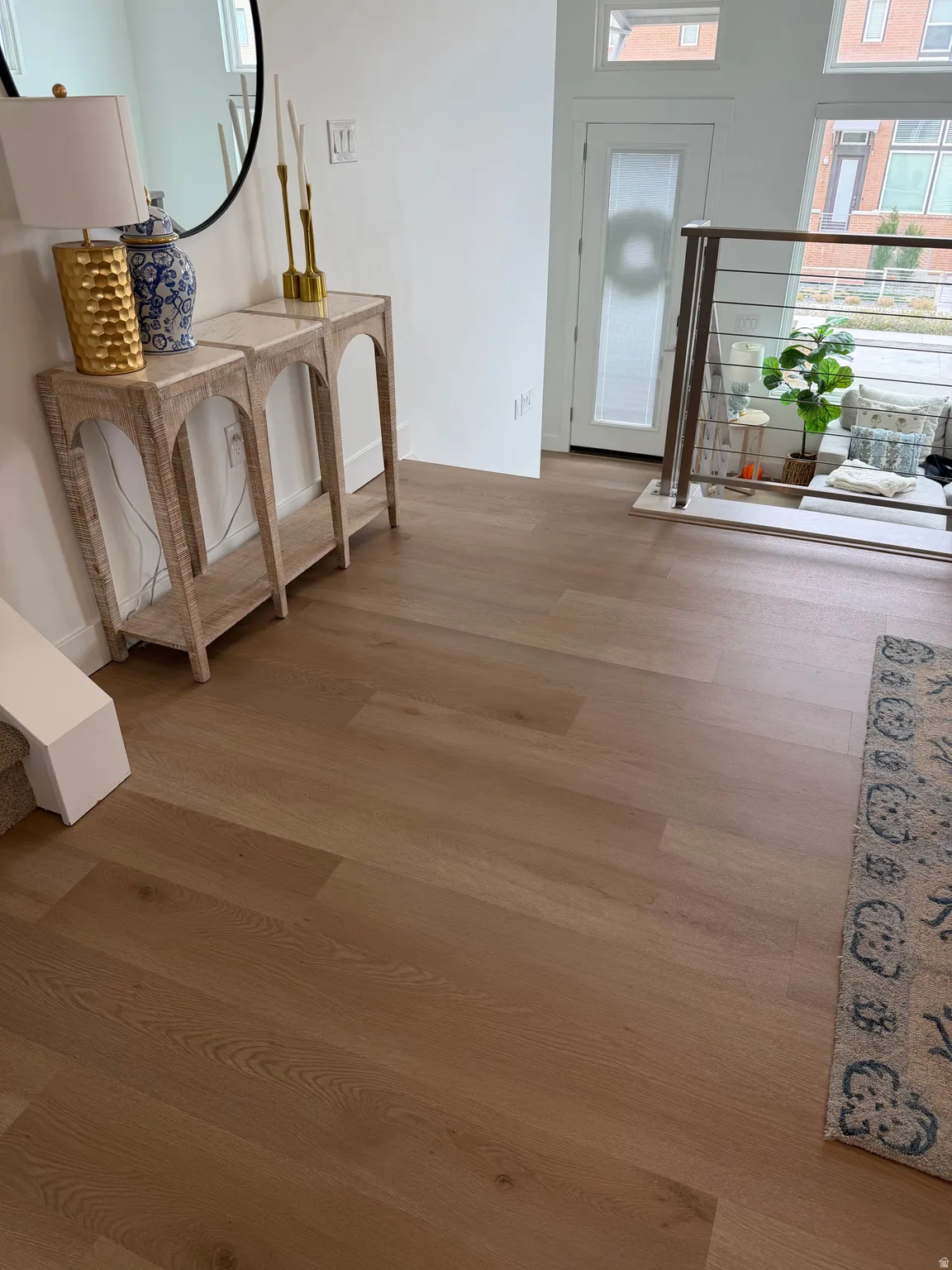 Corridor with plenty of natural light and wood finished floors