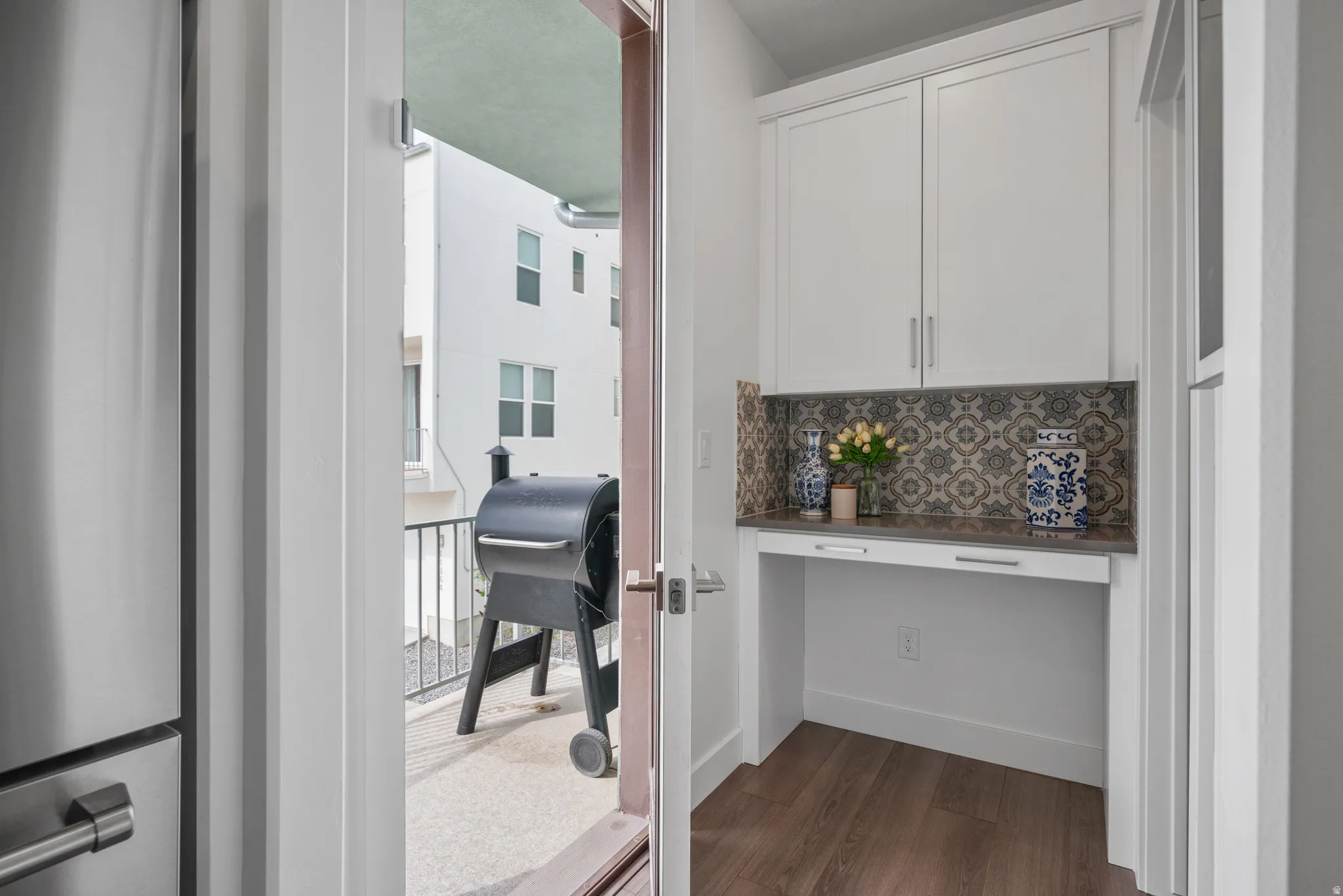 Corridor featuring an office area and dark wood-style flooring