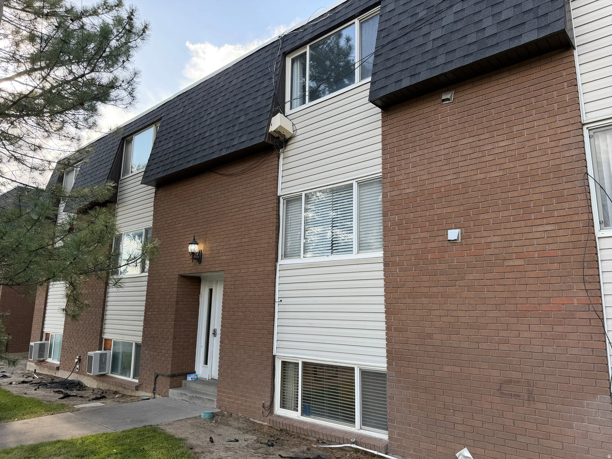 Multi-level building with a dark shingle roof