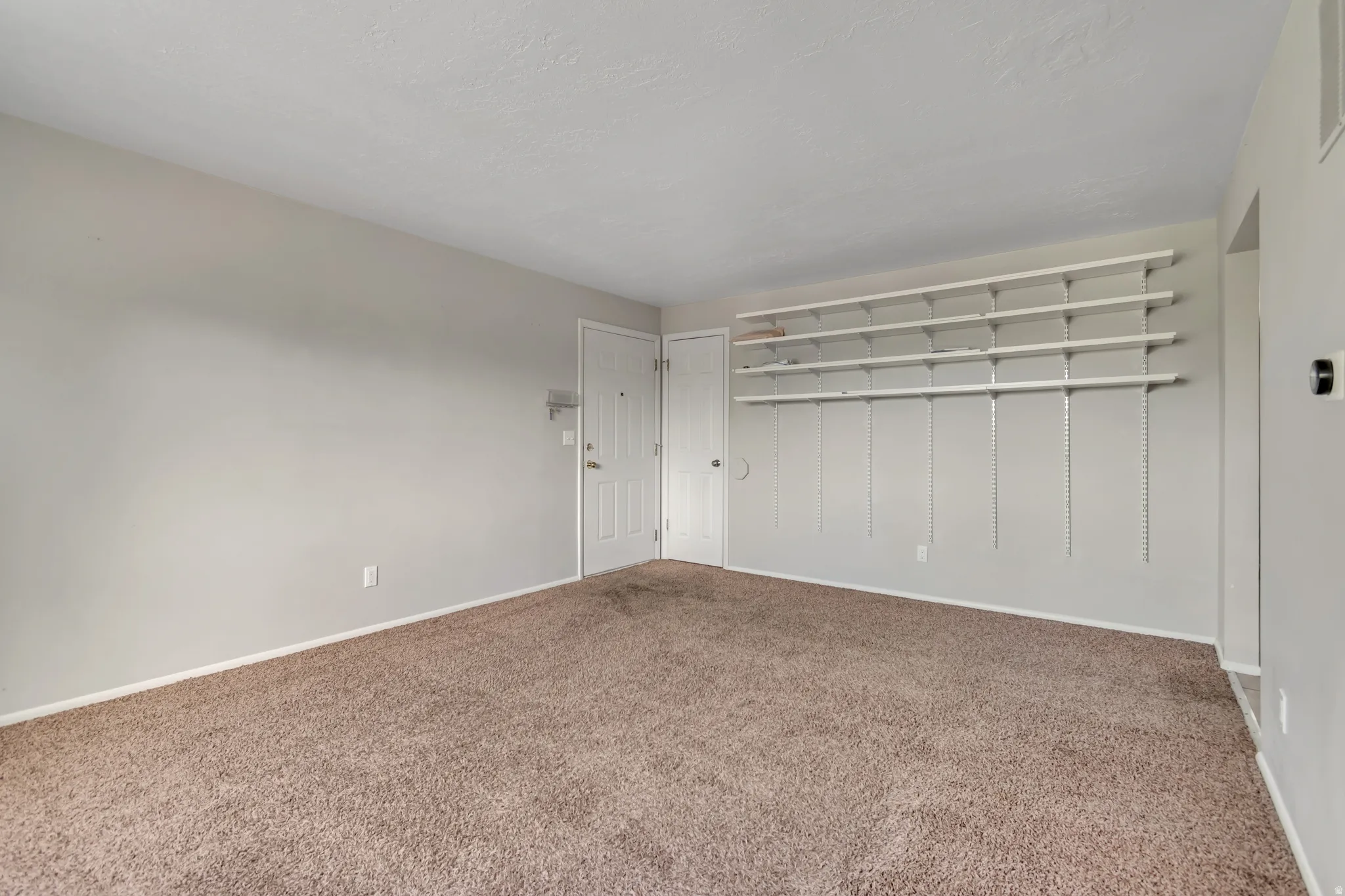 Unfurnished bedroom featuring a closet and carpet floors