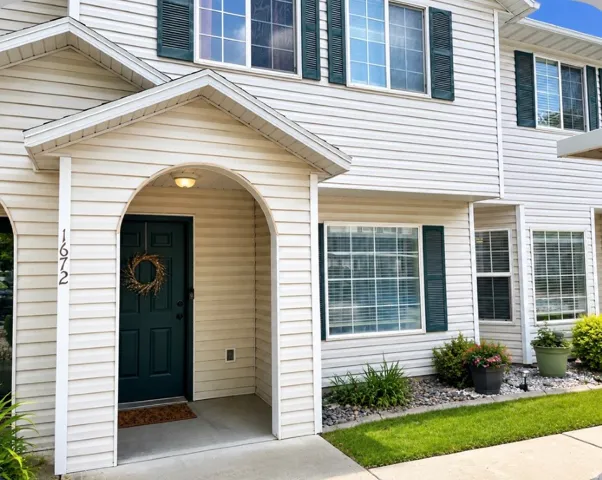 Arched entryway with a dark green front door