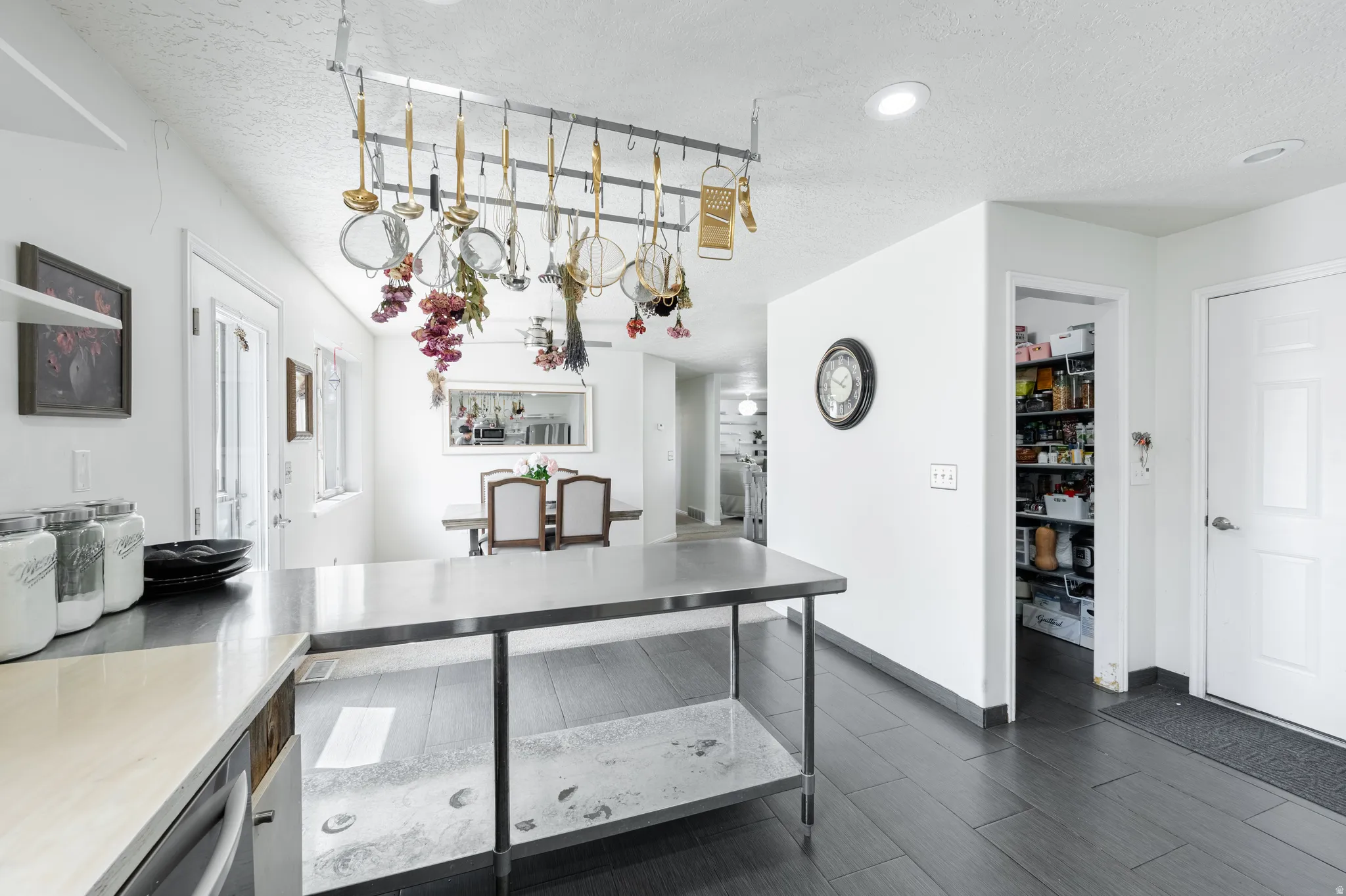Kitchen with a textured ceiling and wood finish floors