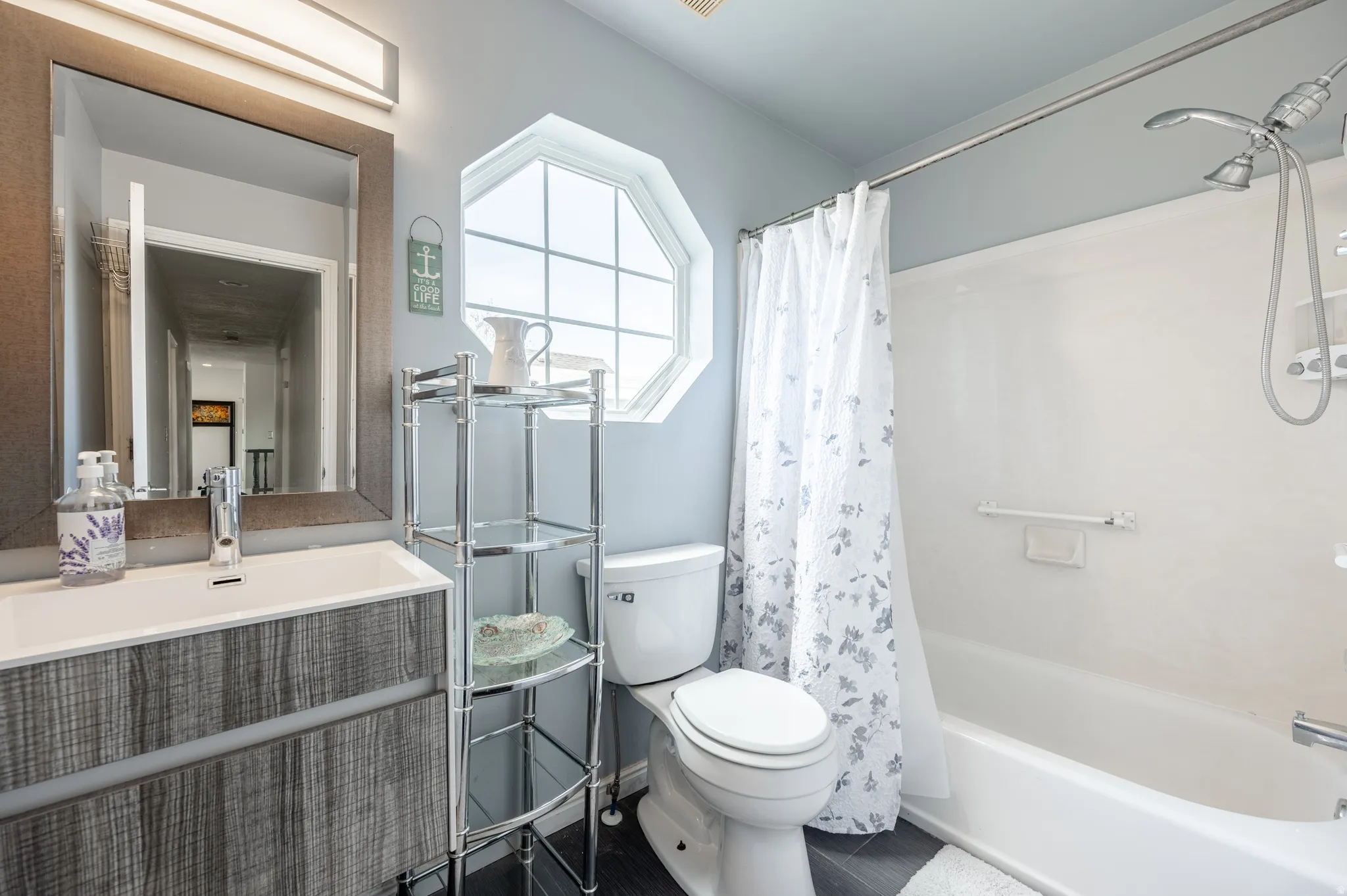 Bathroom featuring shower / bathtub combination with curtain and vanity