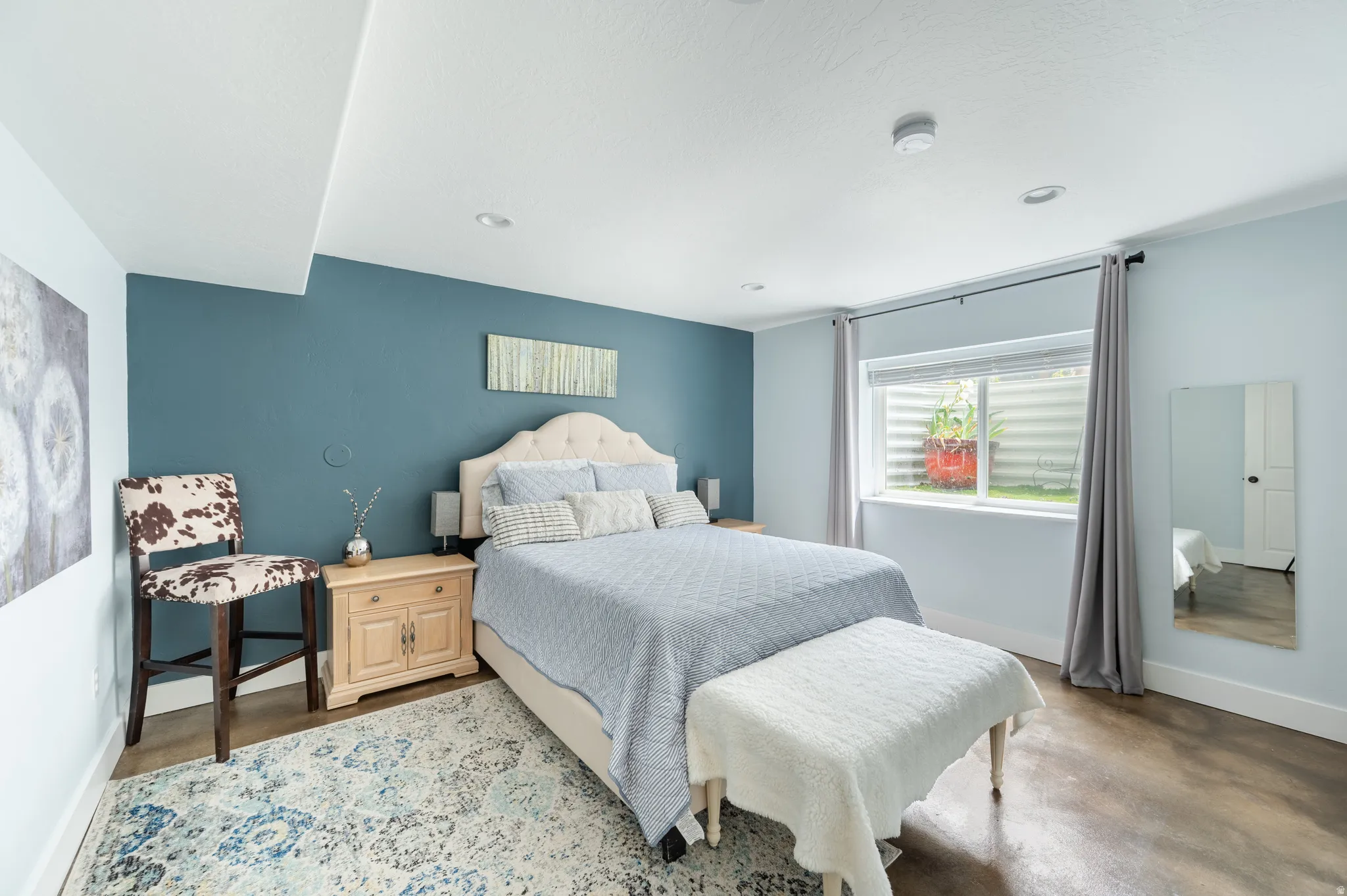 Bedroom with baseboards and finished concrete floors