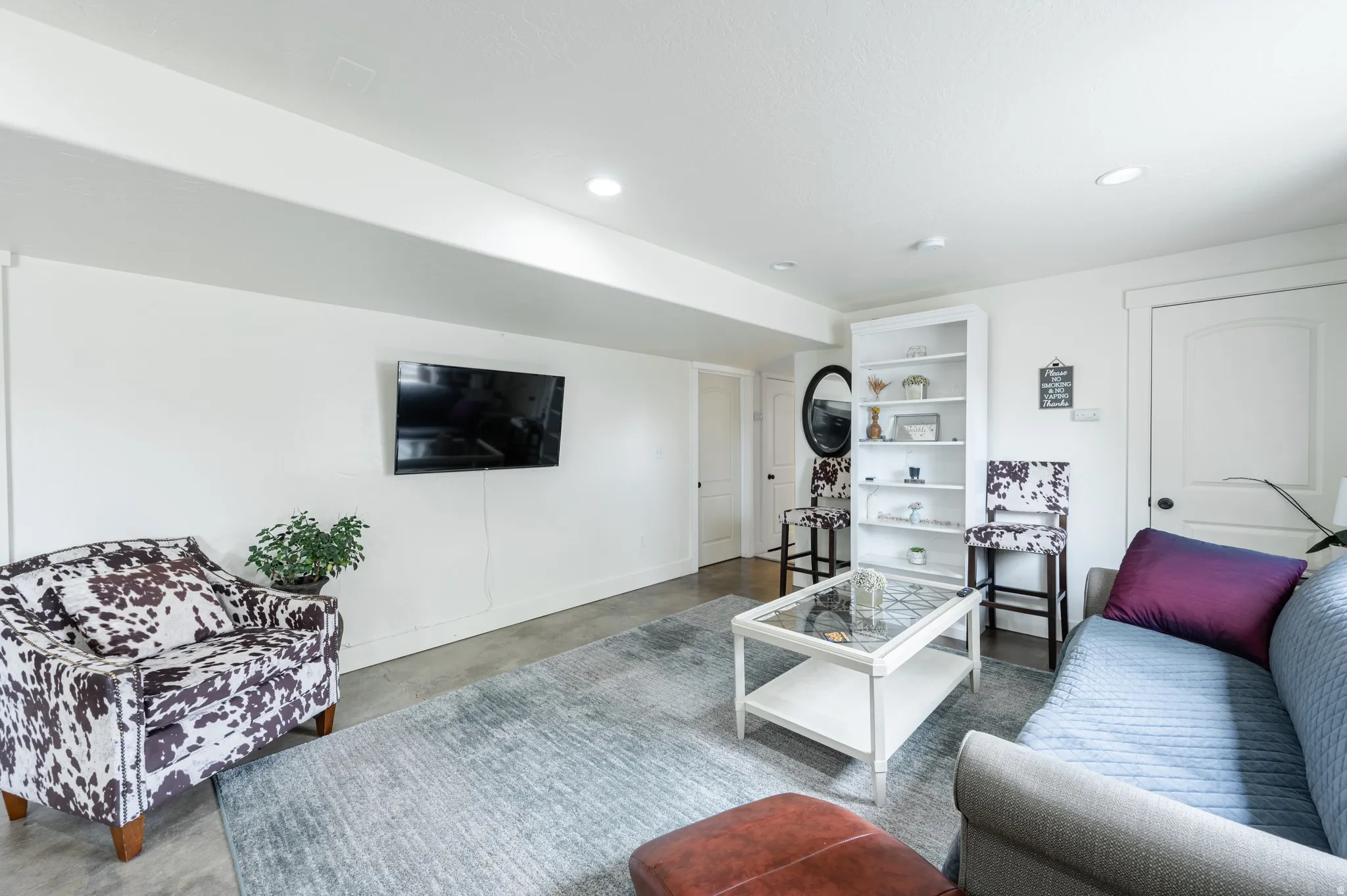 Living room featuring concrete floors and recessed lighting