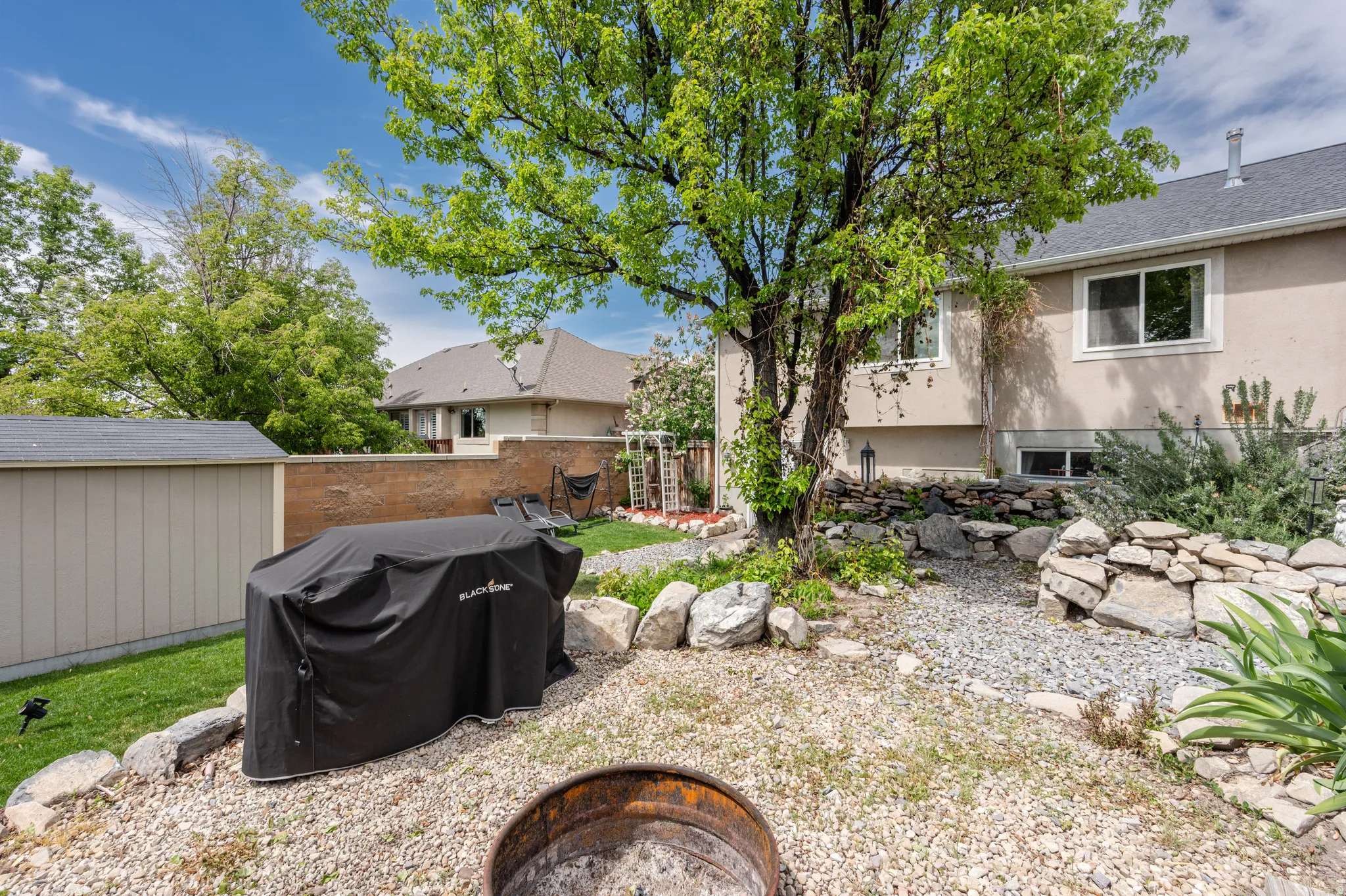 View of yard featuring a fire pit and a storage shed