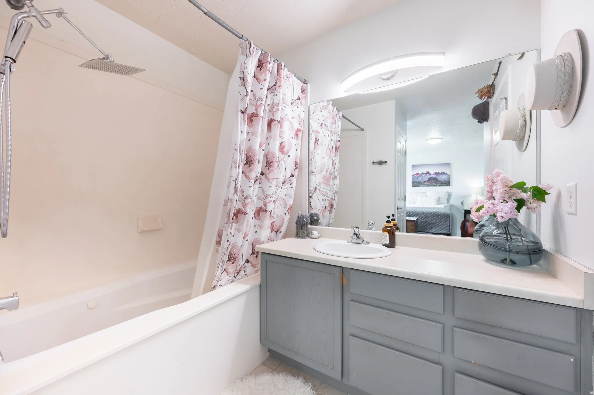 Bathroom with ensuite bath, vanity, and shower / bath combo with shower curtain