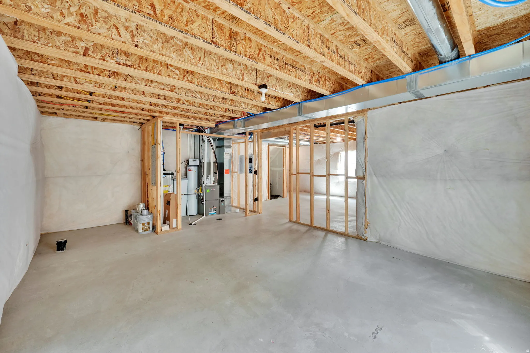 Unfinished below grade area featuring heating unit