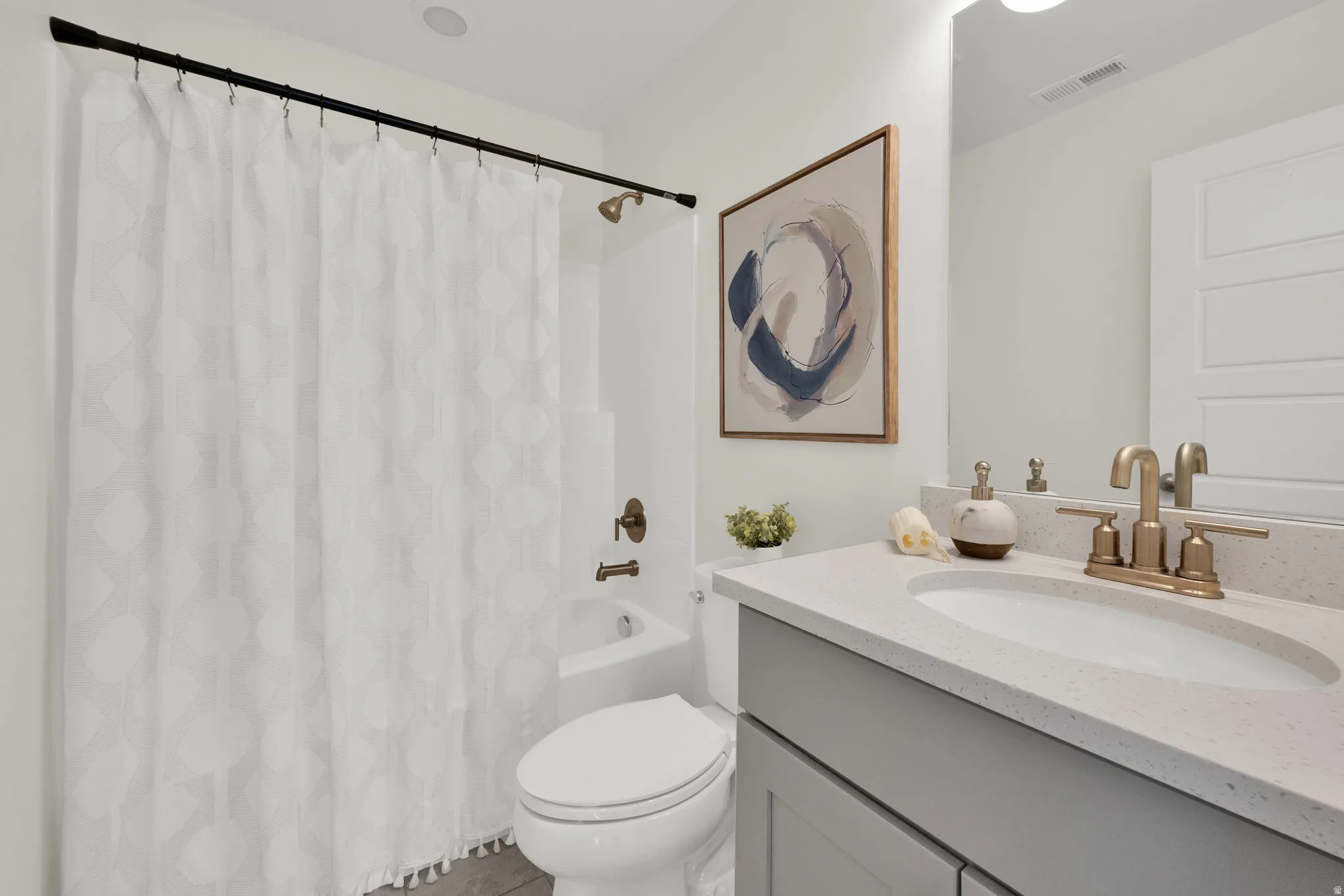 Bathroom featuring vanity and shower / bath combo