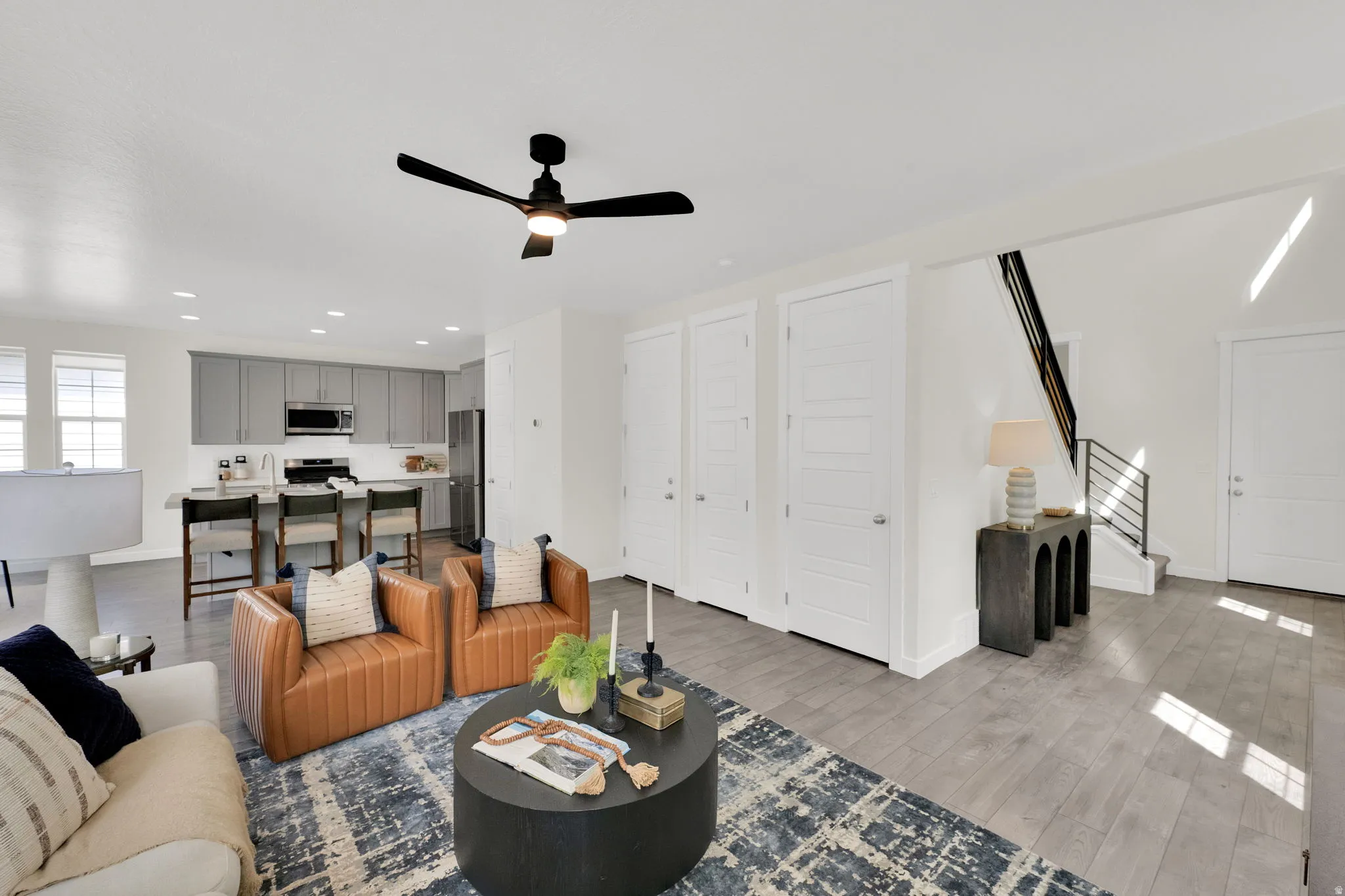 Living area featuring a ceiling fan, recessed lighting, and light wood finished floors