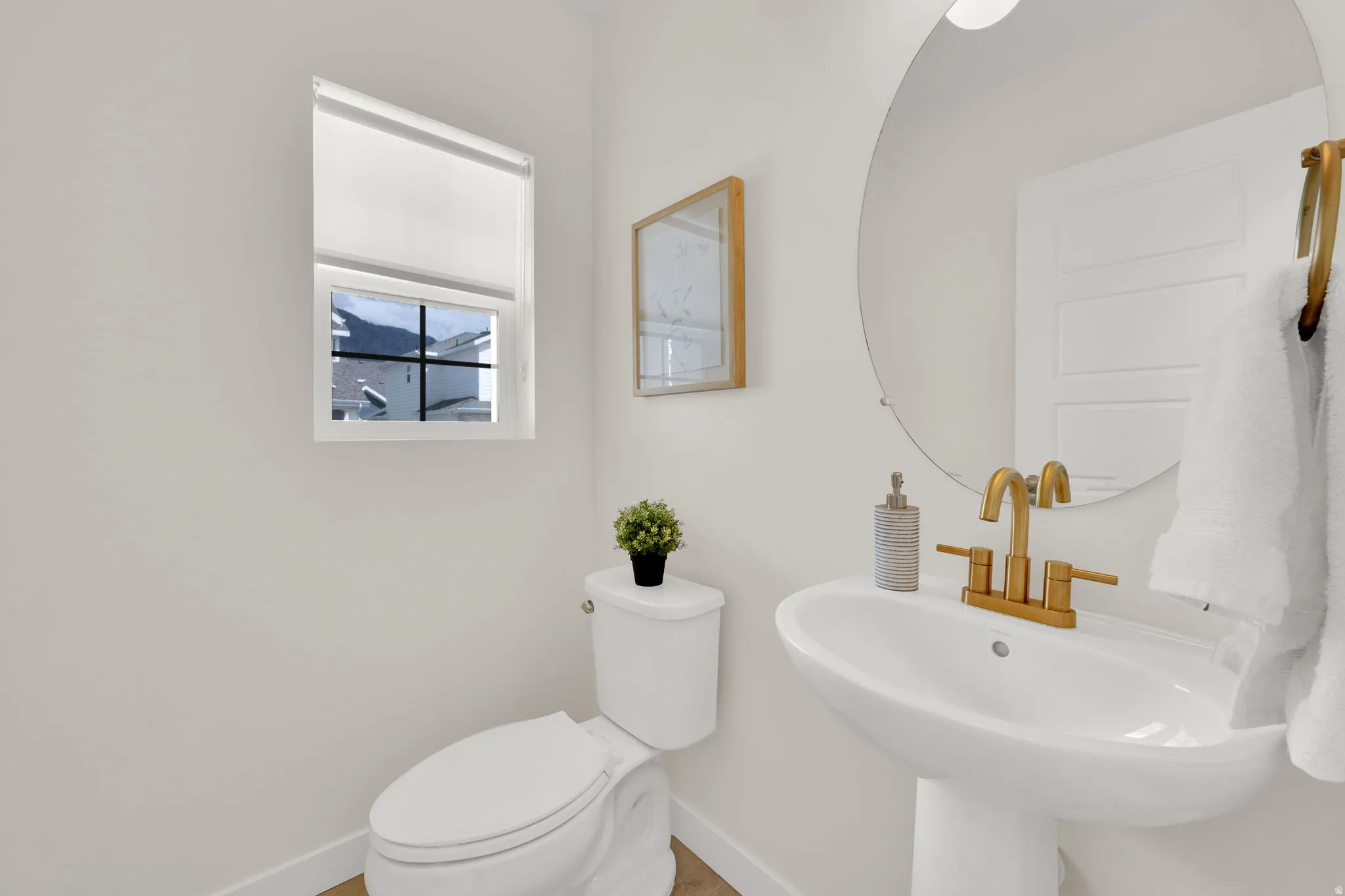 Half Bathroom with toilet and baseboards
