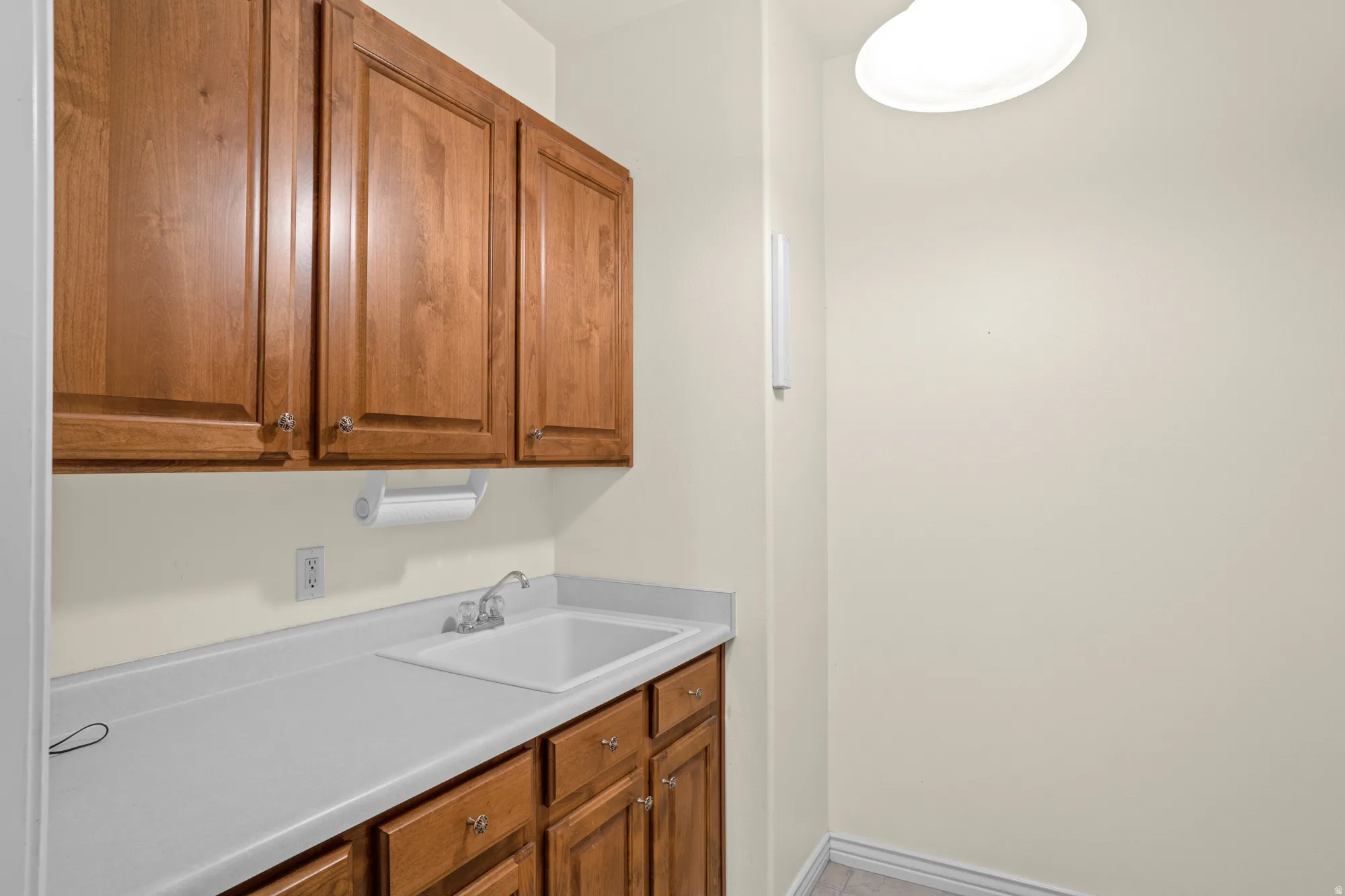 Kitchen featuring wood finish cabinets and light countertops