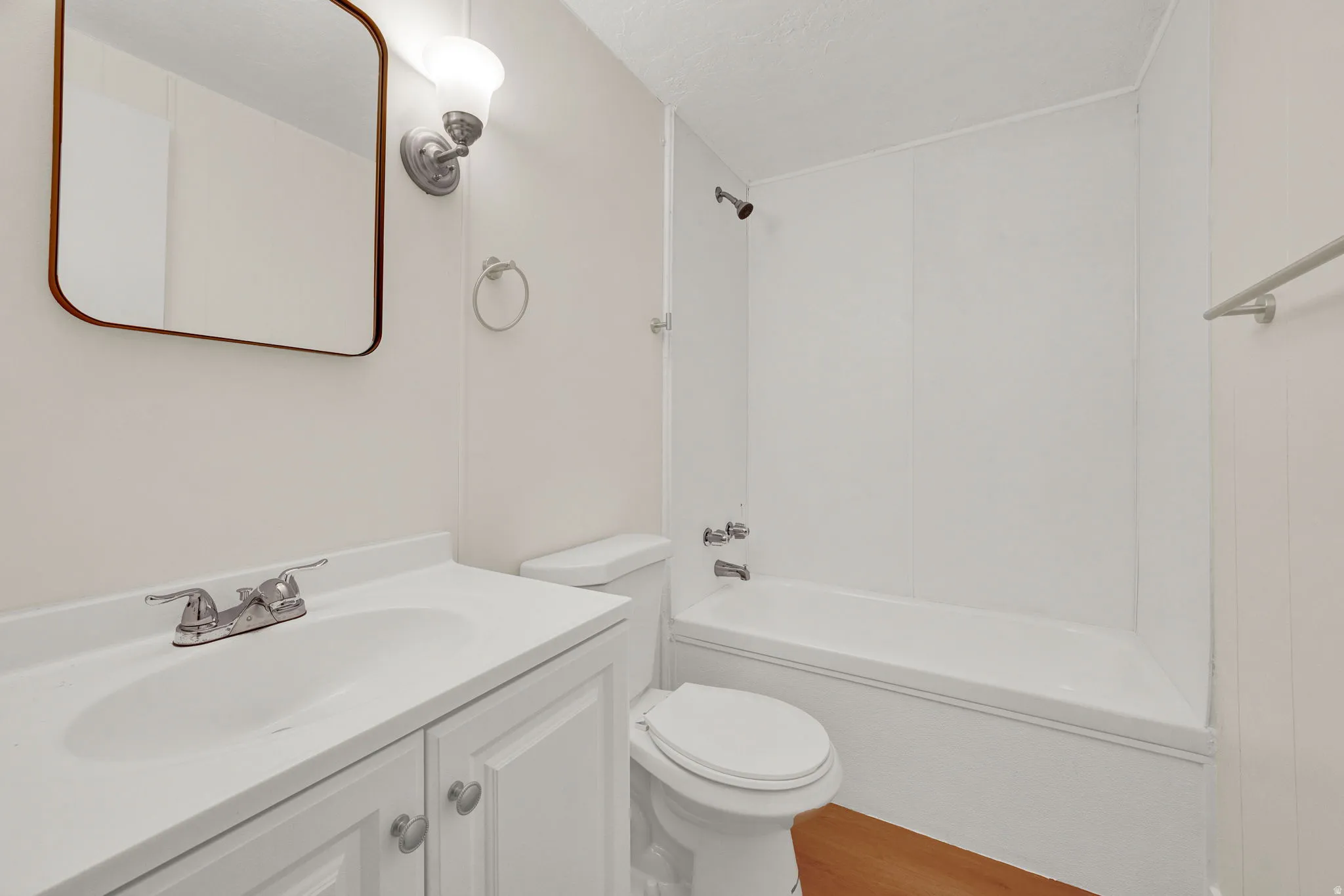 Full bathroom featuring vanity, shower / bath combination, and light wood-type flooring