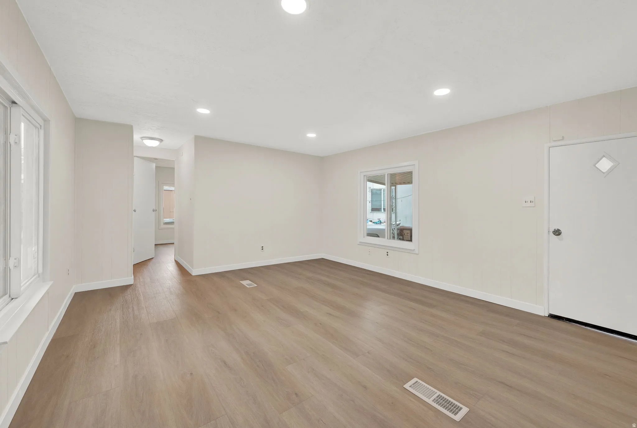 Unfurnished living room with light wood-style floors and recessed lighting