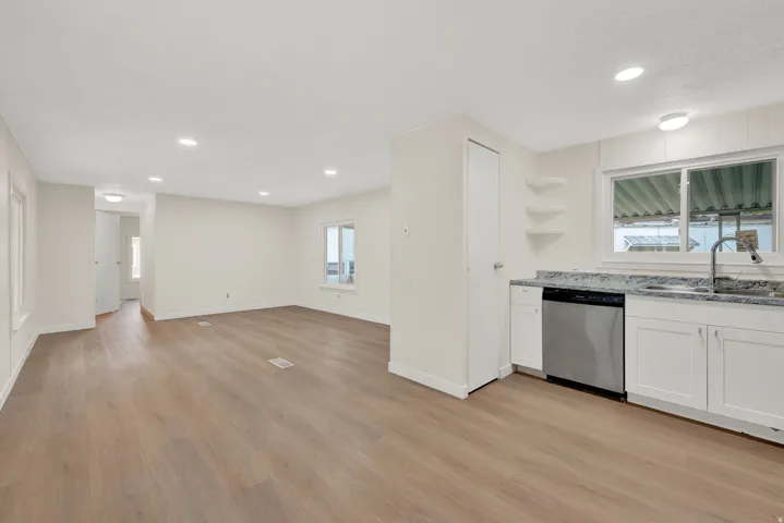 Kitchen featuring open shelves, dishwasher, light wood-style flooring, recessed lighting, and white cabinets