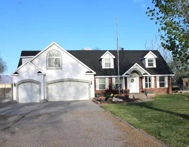 View of front of house with brick siding, and a garage