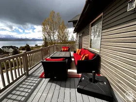 Wooden deck featuring outdoor furniture and a water view