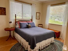 Bedroom with light wood-type flooring and crown molding