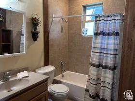 Full bathroom with vanity and shower / tub combo