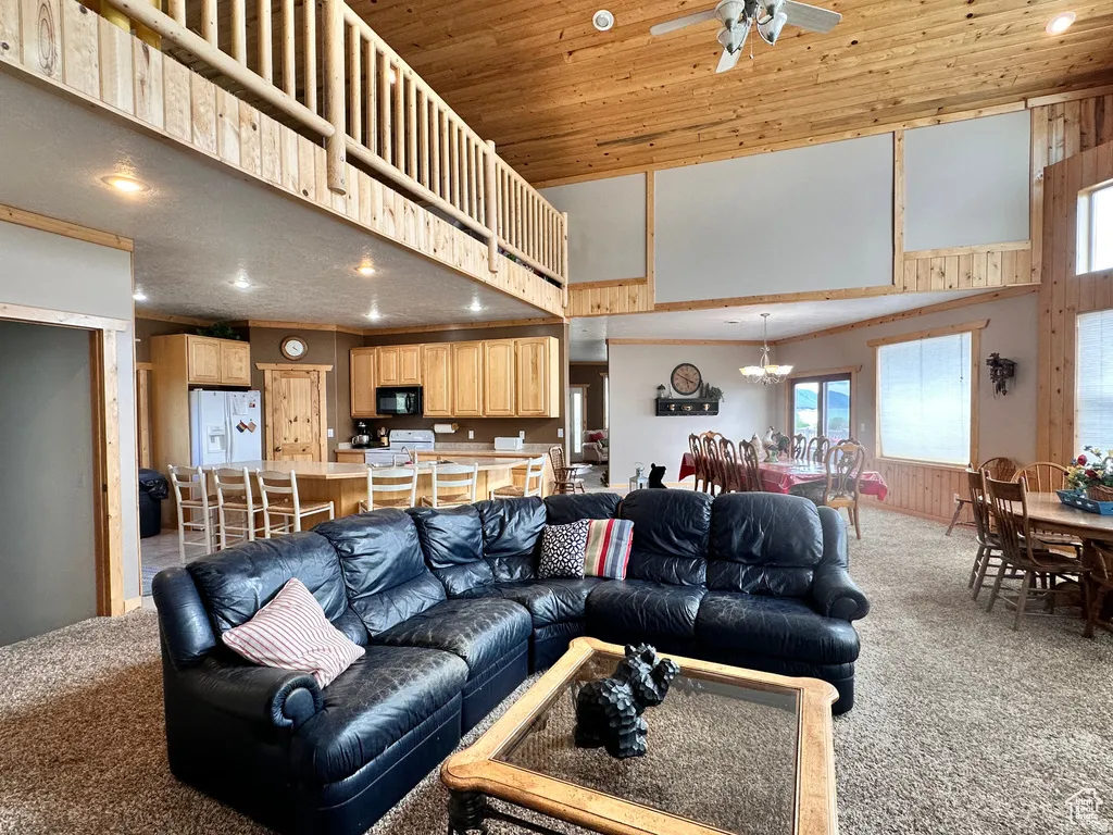 Living area featuring light carpet, recessed lighting, a high wooden ceiling, and ceiling fan